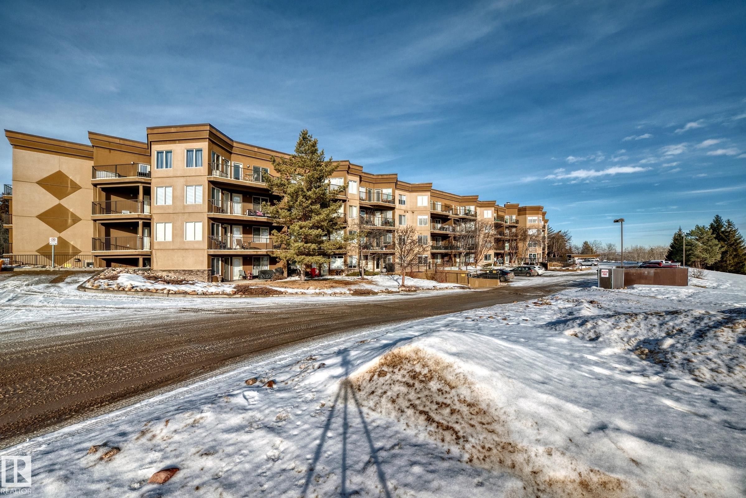 Snow covered property with a view of apartment building / complex - 232 530 Hooke Road, Edmonton, AB - Outdoor With Balcony