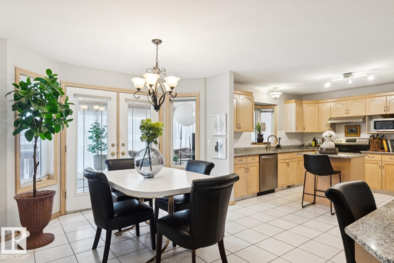 Dining room featuring light tile patterned floors and a chandelier - 8617 158A Avenue, Edmonton, AB - Indoor Photo Showing Dining Room