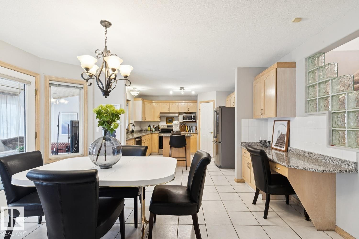 Dining area featuring light tile patterned flooring and a chandelier - 8617 158A Avenue, Edmonton, AB - Indoor Photo Showing Dining Room