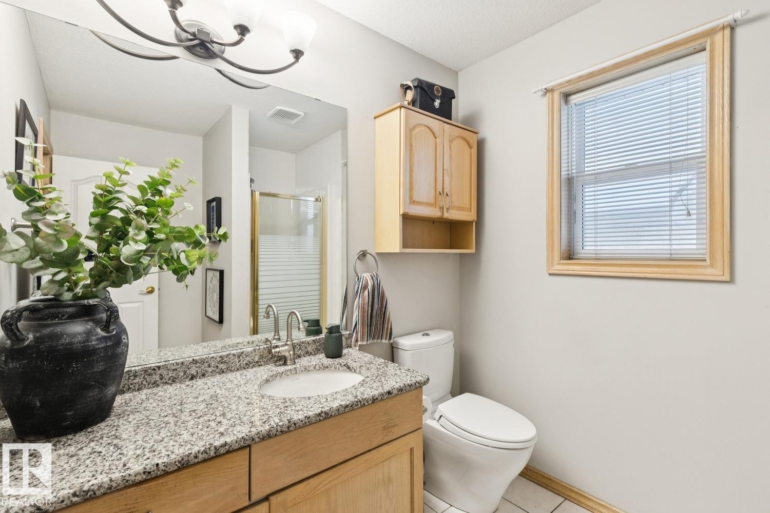 Bathroom featuring vanity, a stall shower, a chandelier, and light tile patterned flooring - 8617 158A Avenue, Edmonton, AB - Indoor Photo Showing Bathroom