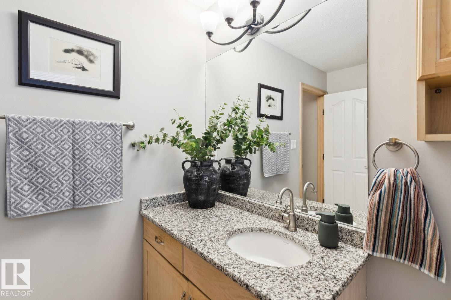 Bathroom featuring vanity and a chandelier - 8617 158A Avenue, Edmonton, AB - Indoor Photo Showing Bathroom