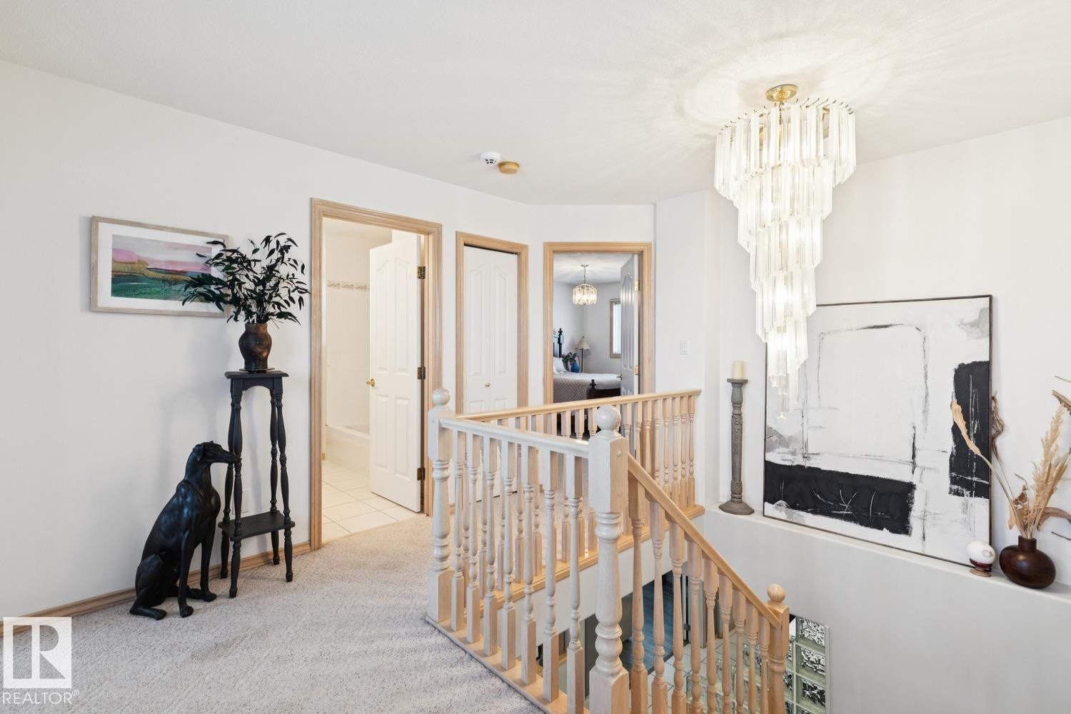 Hall featuring an upstairs landing, carpet, and a chandelier - 8617 158A Avenue, Edmonton, AB - Indoor Photo Showing Other Room