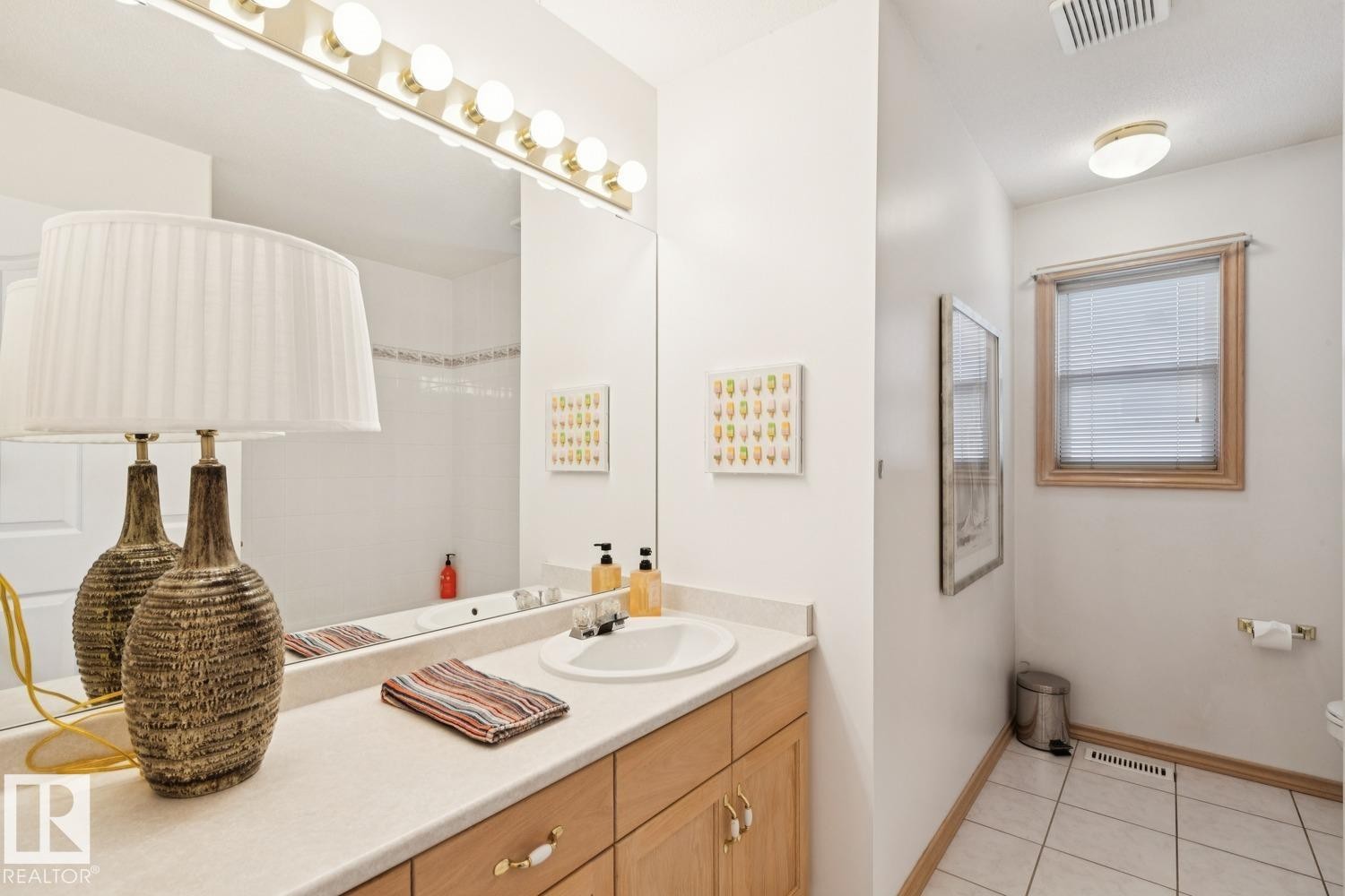 Full bathroom with vanity and light tile patterned floors - 8617 158A Avenue, Edmonton, AB - Indoor Photo Showing Bathroom