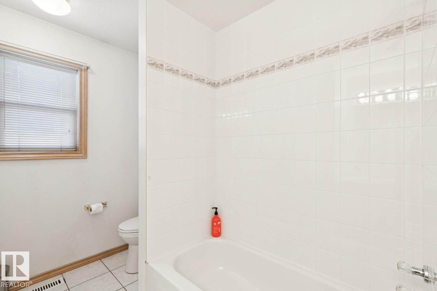 Full bathroom with bathing tub / shower combination and light tile patterned floors - 8617 158A Avenue, Edmonton, AB - Indoor Photo Showing Bathroom