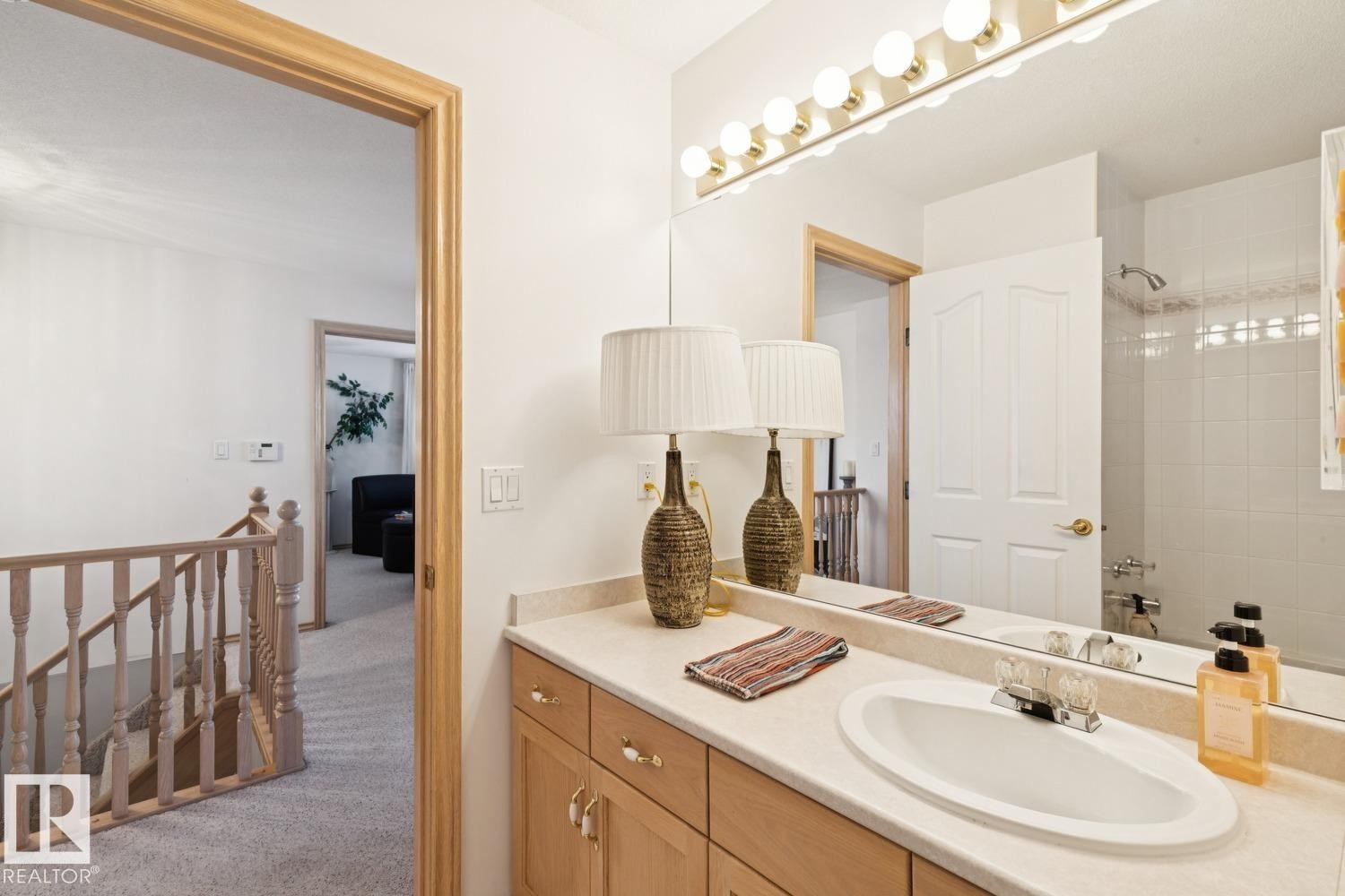 Bathroom with vanity, light colored carpet, and tub / shower combination - 8617 158A Avenue, Edmonton, AB - Indoor Photo Showing Bathroom
