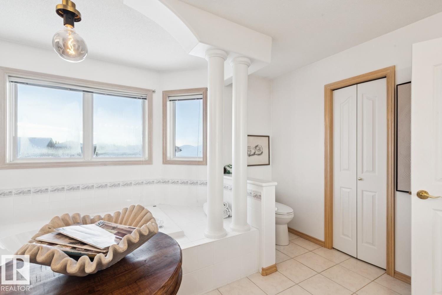 Bathroom with light tile patterned flooring and a relaxing tiled tub - 8617 158A Avenue, Edmonton, AB - Indoor
