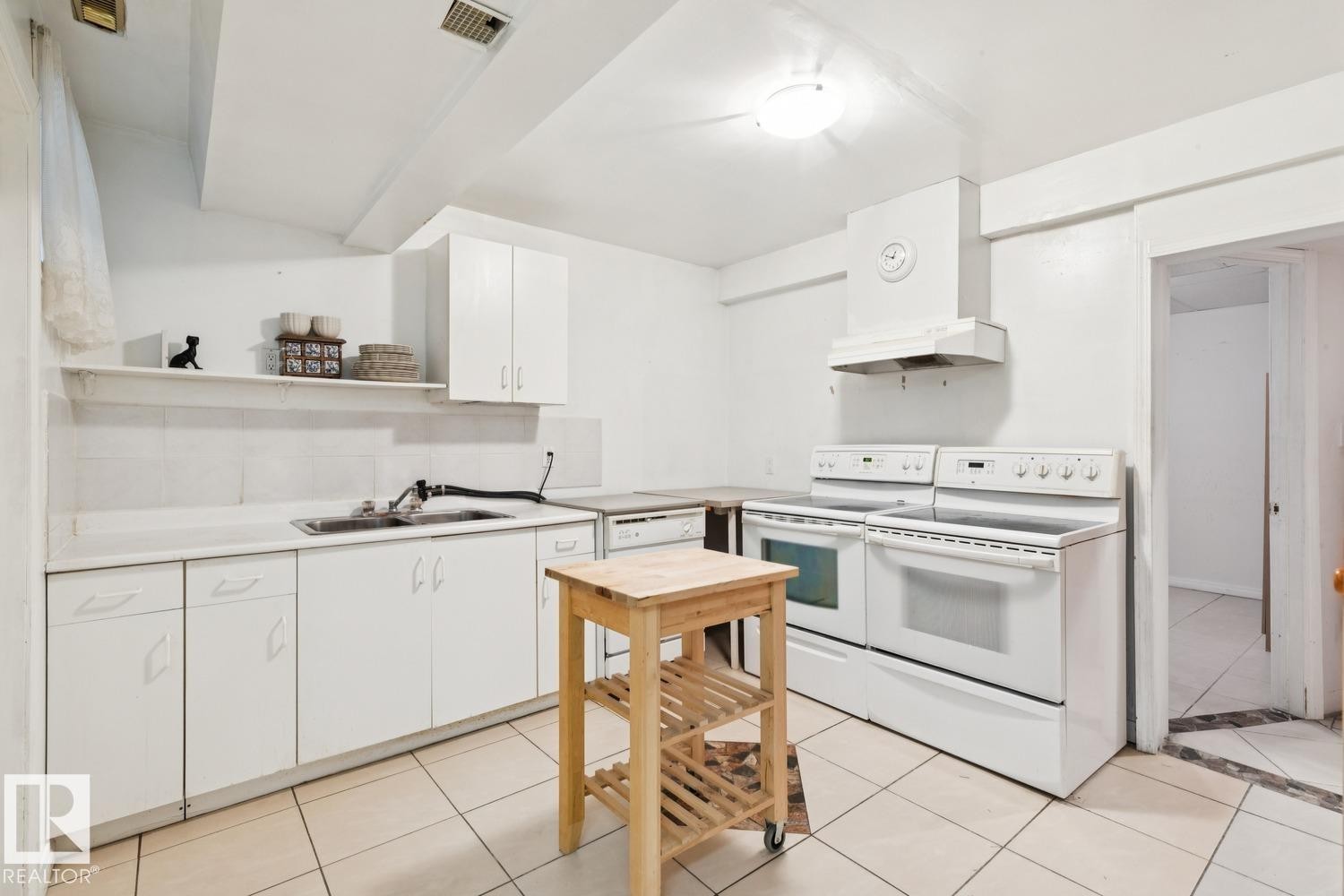 Kitchen featuring electric range, light countertops, white cabinets, and open shelves - 8617 158A Avenue, Edmonton, AB - Indoor Photo Showing Kitchen With Double Sink