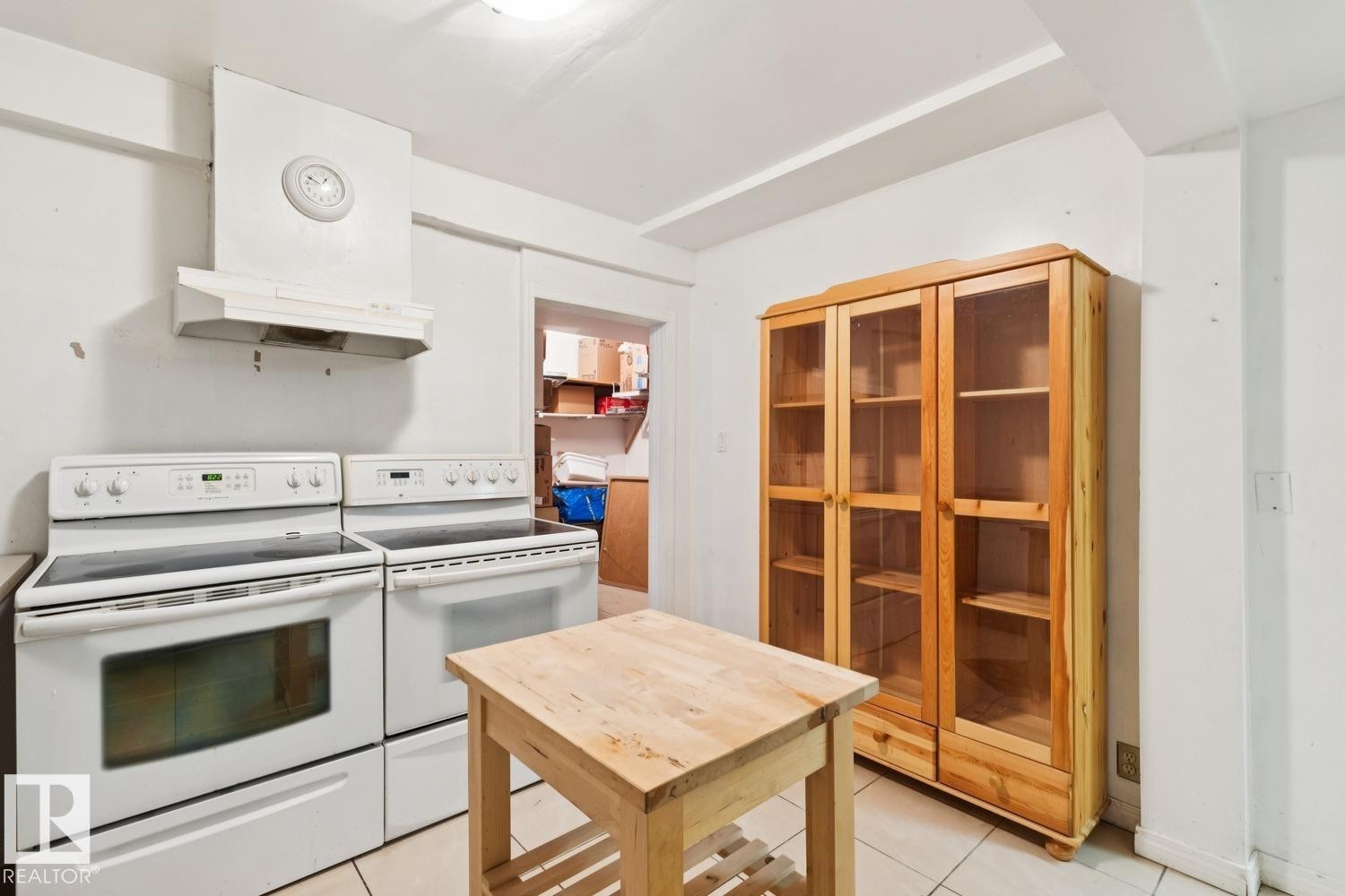 Kitchen featuring electric range, light tile patterned floors, and under cabinet range hood - 8617 158A Avenue, Edmonton, AB - Indoor Photo Showing Kitchen