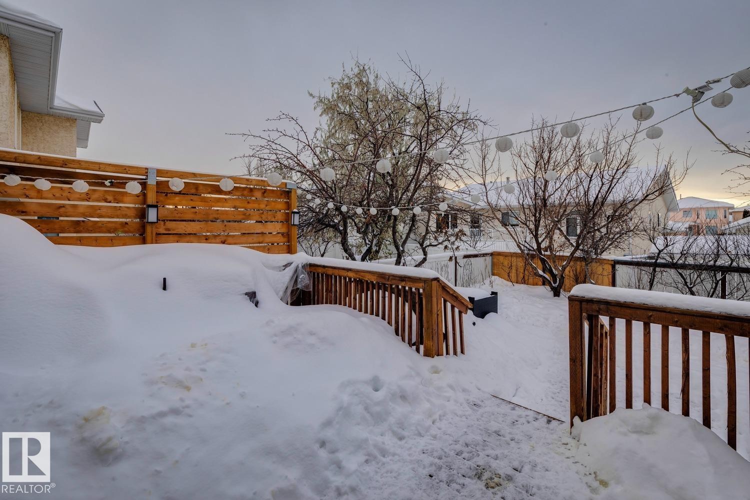 Yard covered in snow with a deck - 8617 158A Avenue, Edmonton, AB - Outdoor