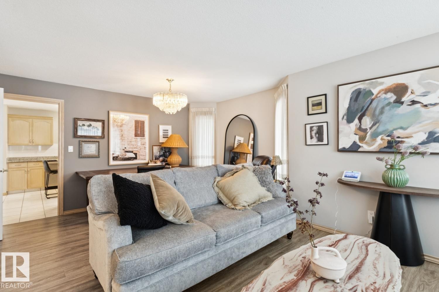 Living area featuring a chandelier and light wood finished floors - 8617 158A Avenue, Edmonton, AB - Indoor Photo Showing Living Room