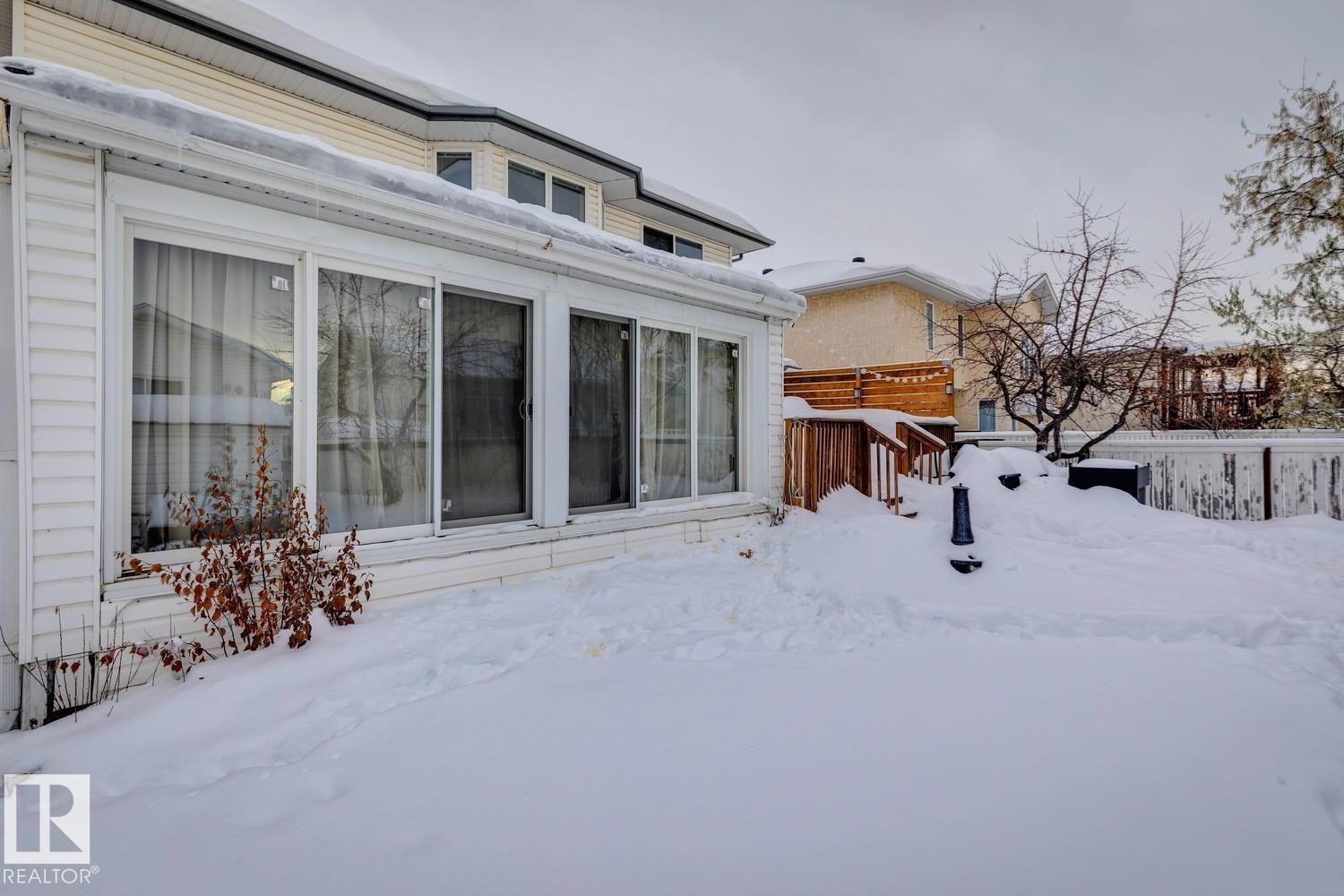 Snow covered property with a deck - 8617 158A Avenue, Edmonton, AB - Outdoor