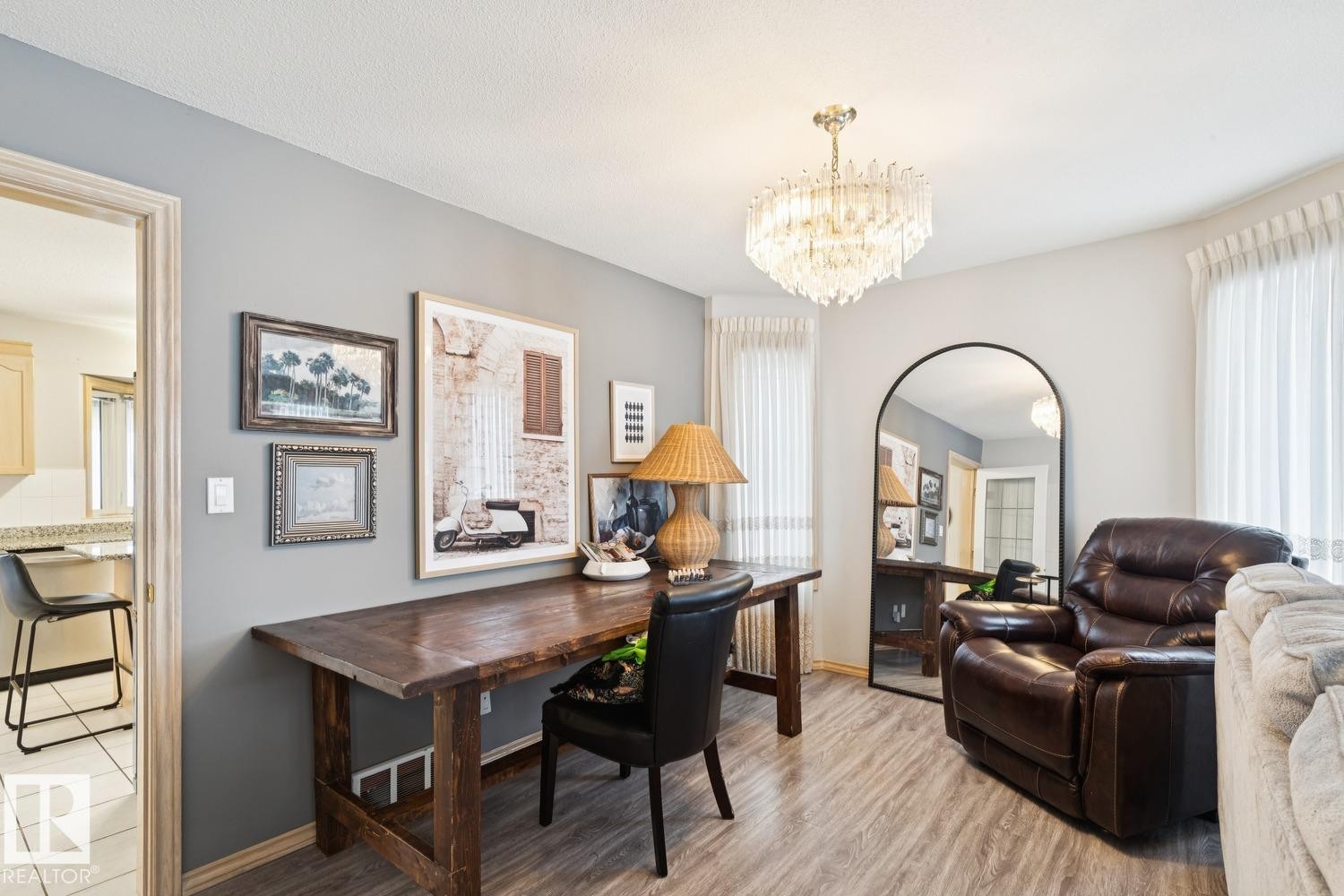 Office area with a chandelier and light wood finished floors - 8617 158A Avenue, Edmonton, AB - Indoor Photo Showing Dining Room