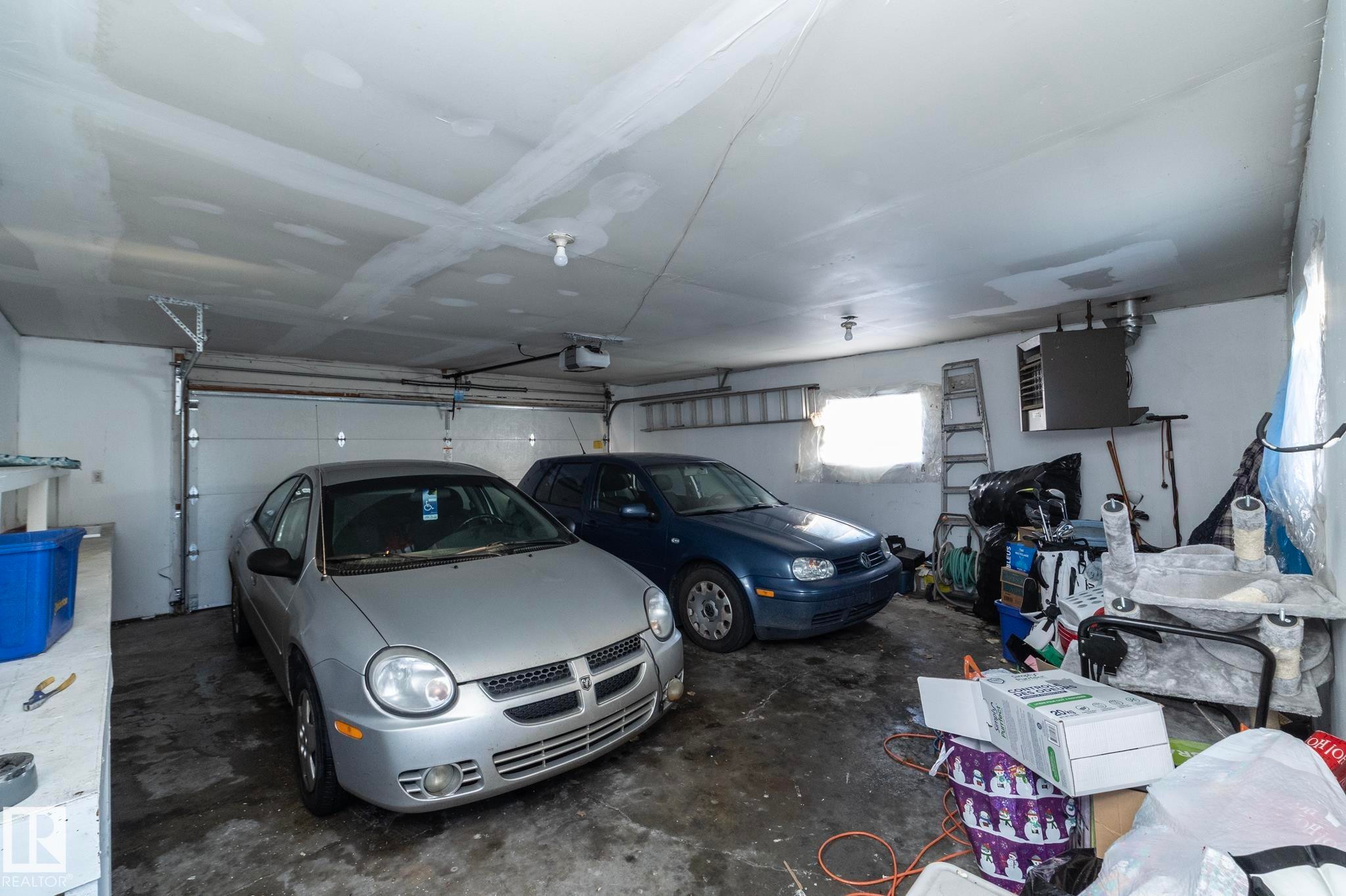 Garage featuring a heating unit and a garage door opener - 9020 152 Avenue, Edmonton, AB - Indoor Photo Showing Garage