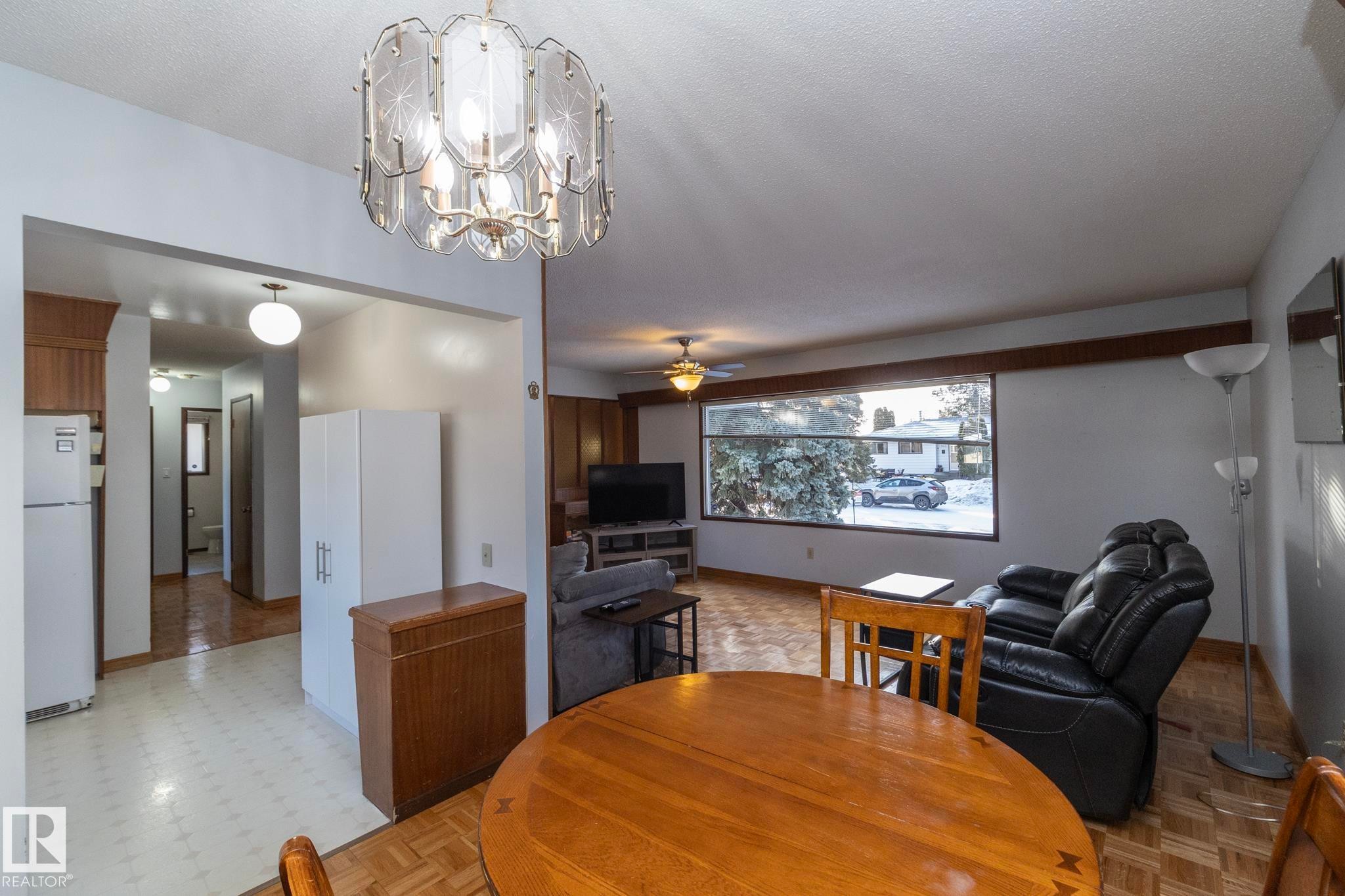 Dining area with ceiling fan and suspended lighting - 9020 152 Avenue, Edmonton, AB - Indoor Photo Showing Dining Room