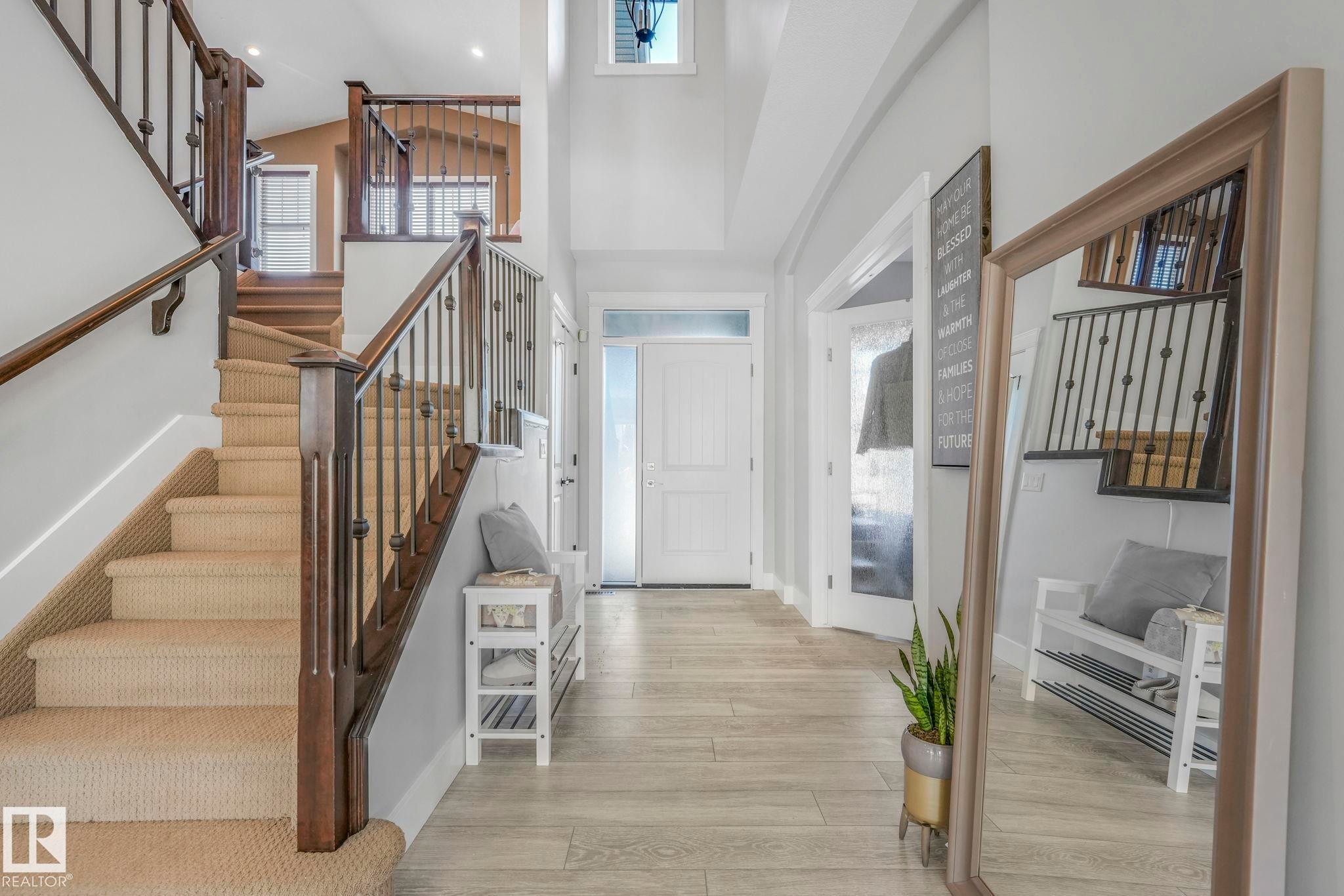 Foyer with stairway, healthy amount of natural light, light wood-style floors, and high vaulted ceiling - 2307 Rutherford Way, Edmonton, AB - Indoor Photo Showing Other Room