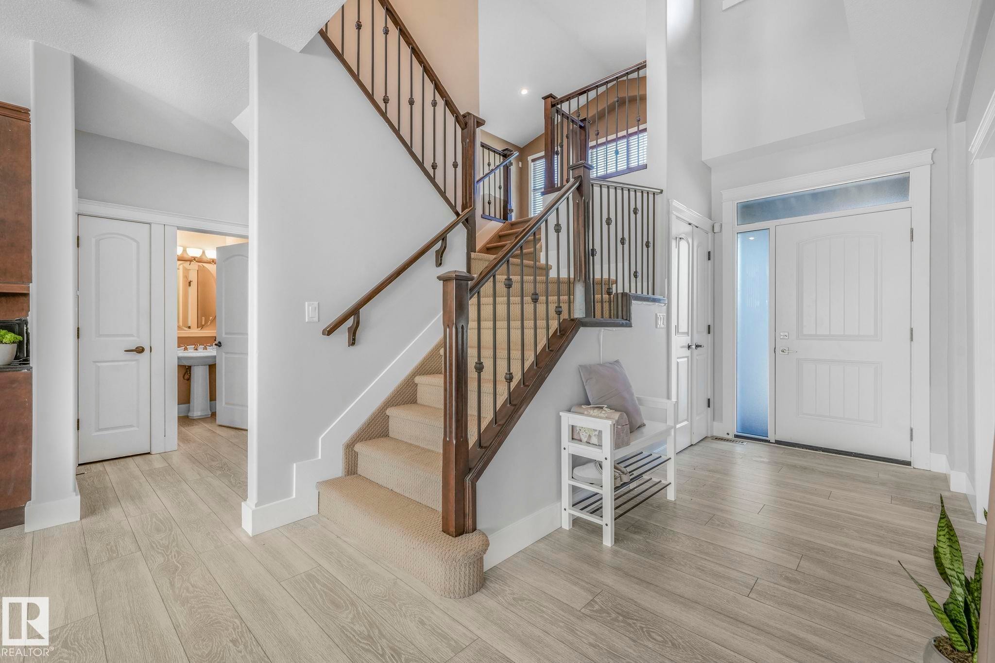 Entryway featuring a towering ceiling, light wood finished floors, and stairway - 2307 Rutherford Way, Edmonton, AB - Indoor Photo Showing Other Room