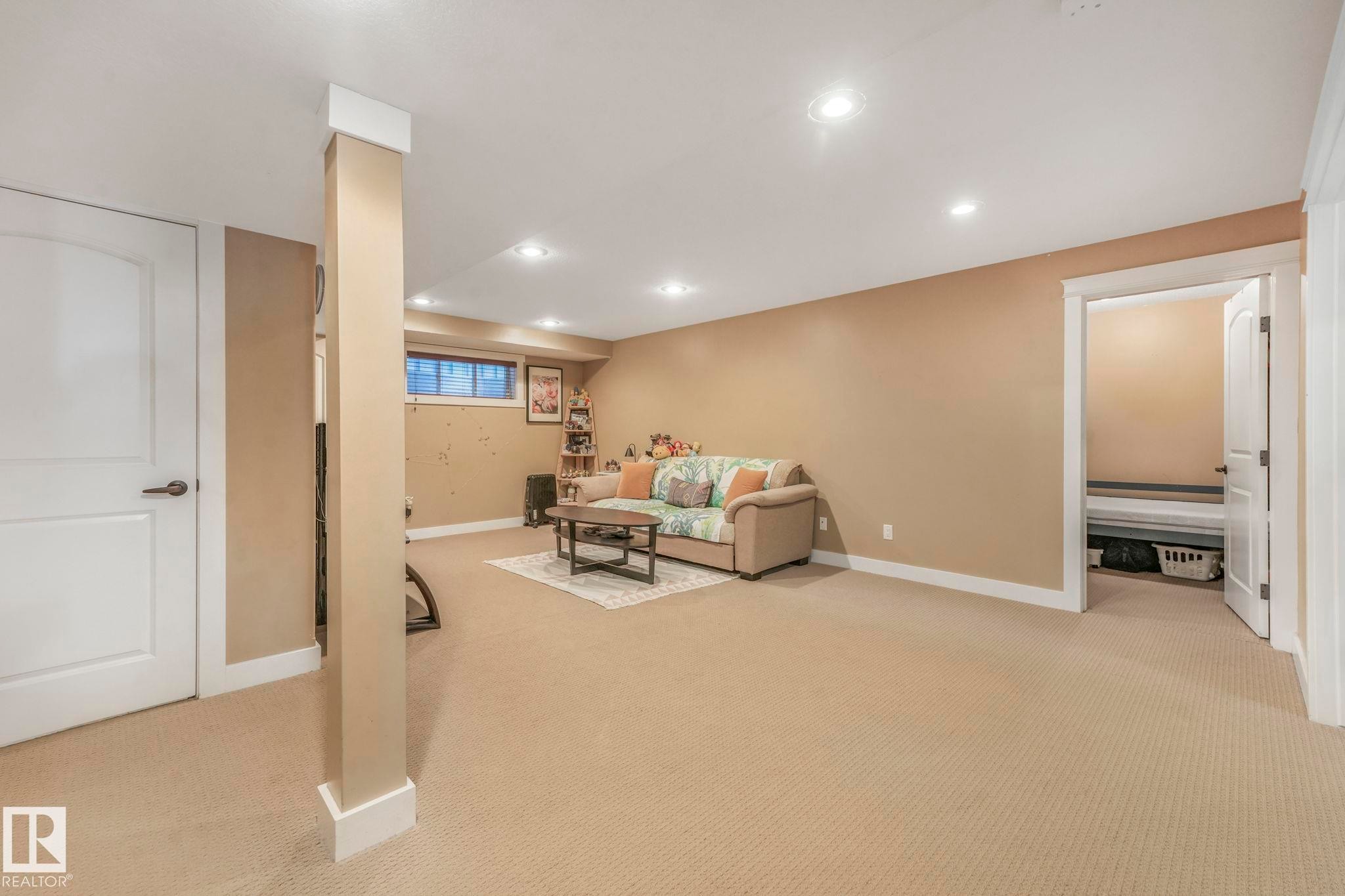 Living room featuring light carpet and recessed lighting - 2307 Rutherford Way, Edmonton, AB - Indoor