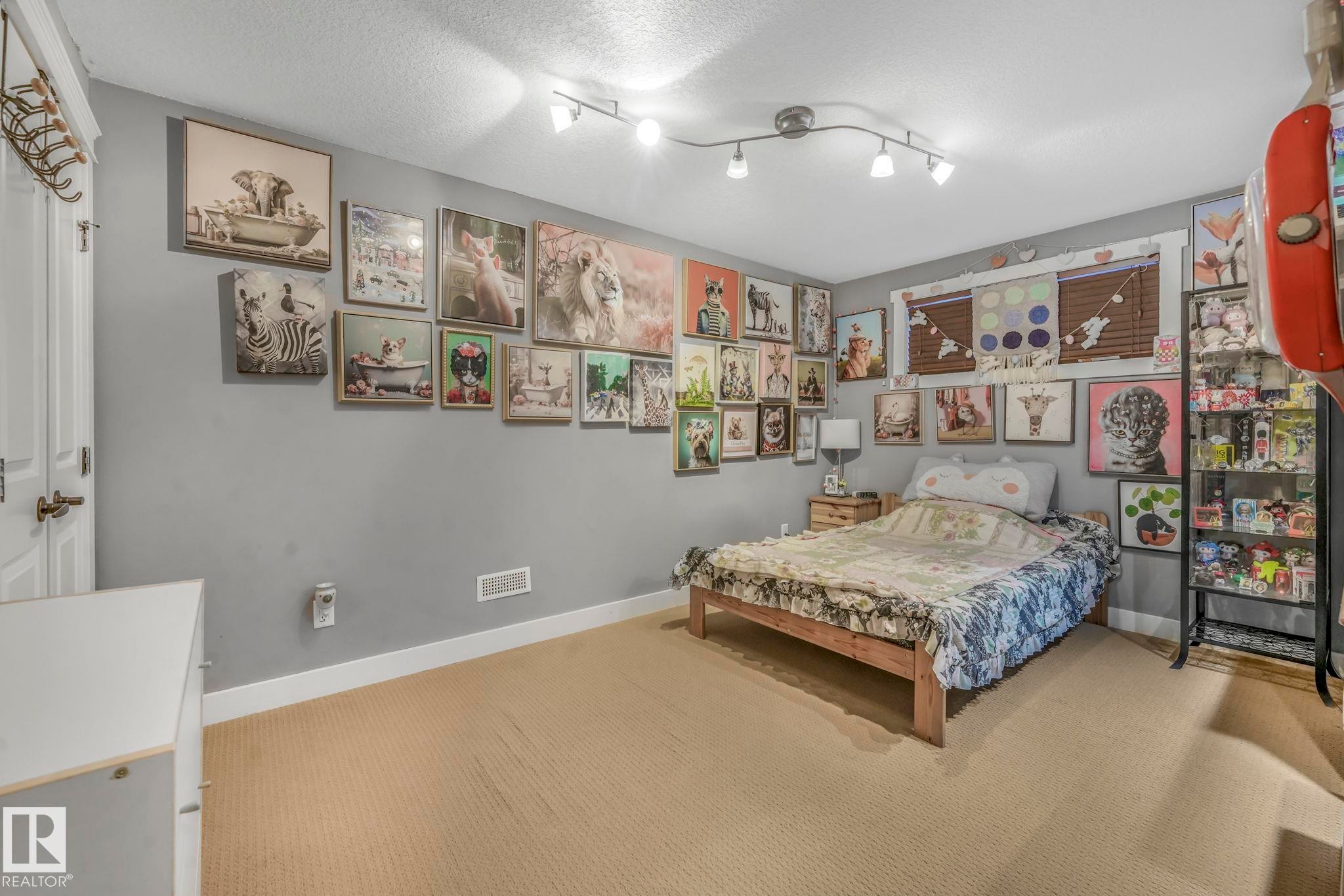 Carpeted bedroom with baseboards and a textured ceiling - 2307 Rutherford Way, Edmonton, AB - Indoor Photo Showing Bedroom