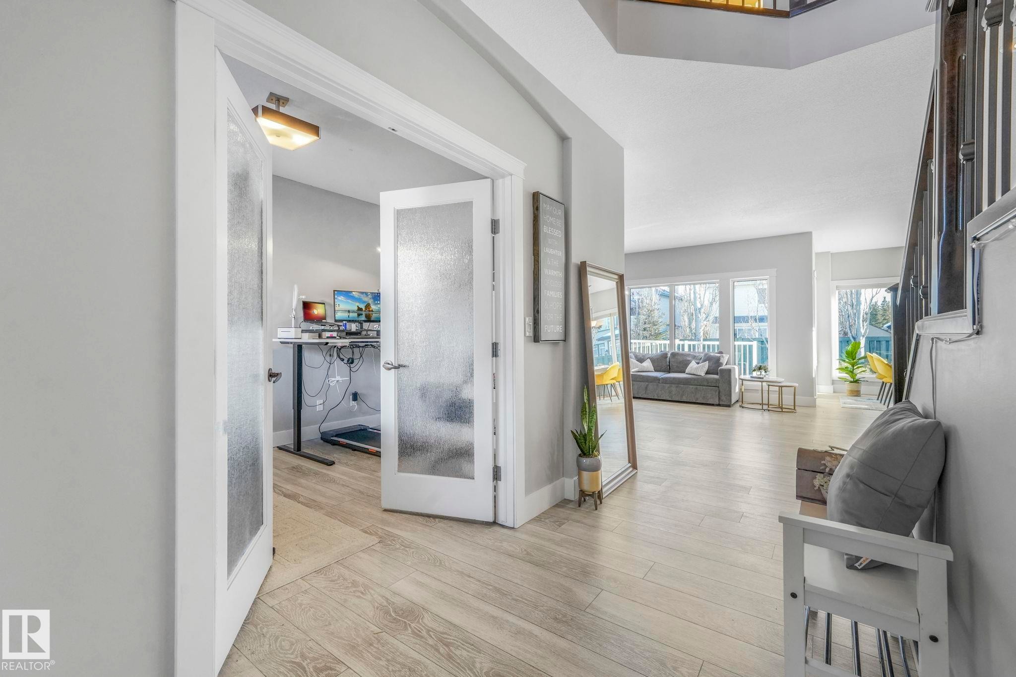 Corridor with light wood-style floors and french doors - 2307 Rutherford Way, Edmonton, AB - Indoor Photo Showing Other Room