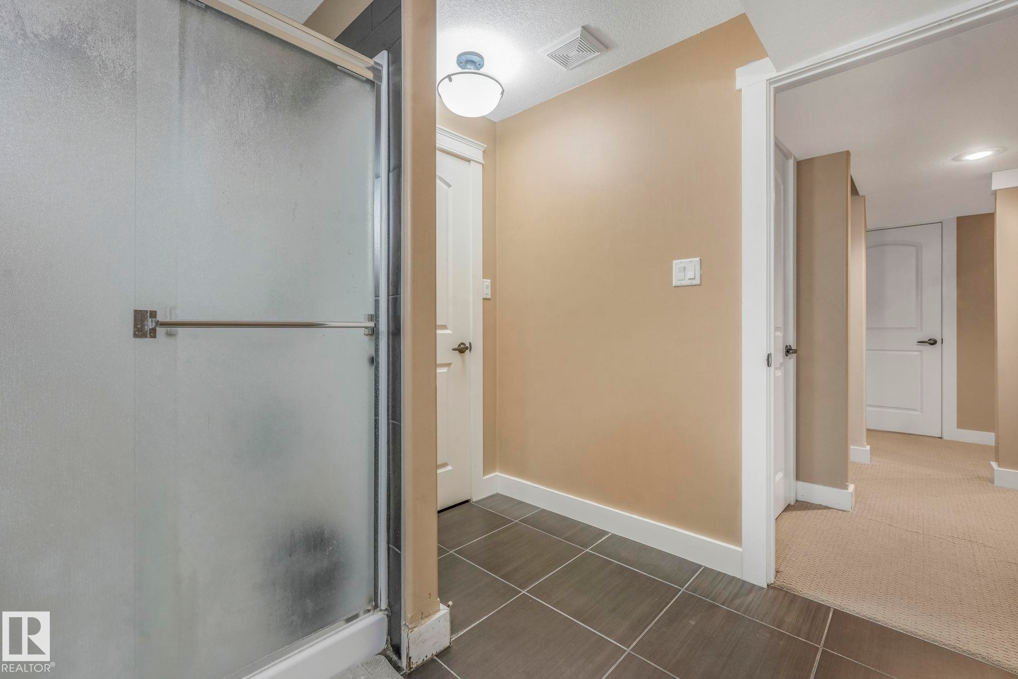Bathroom with a stall shower and tile patterned floors - 2307 Rutherford Way, Edmonton, AB - Indoor