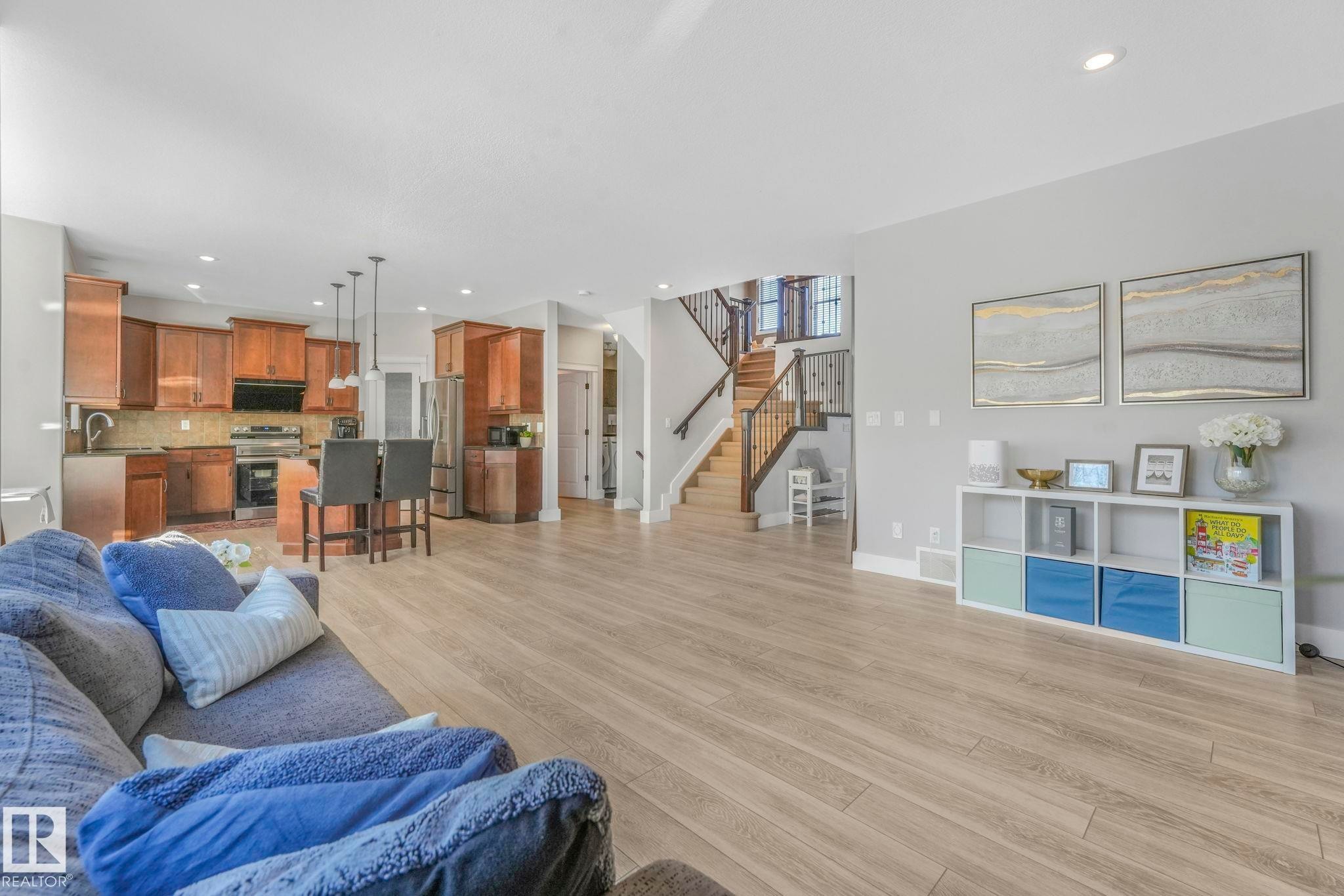 Living room featuring stairway, recessed lighting, and light wood-style floors - 2307 Rutherford Way, Edmonton, AB - Indoor Photo Showing Living Room