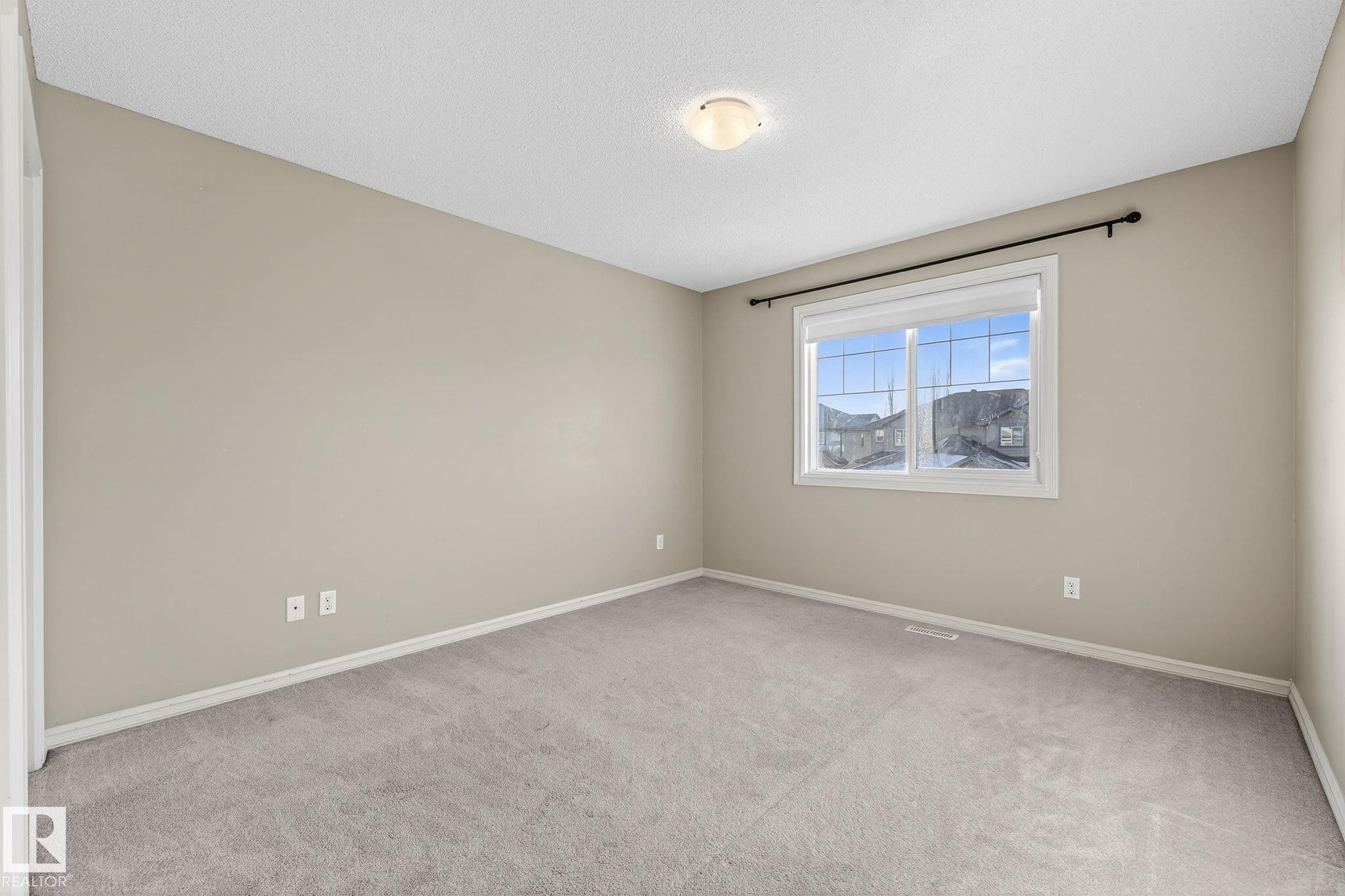 Unfurnished room with light carpet and a textured ceiling - 2338 Casselman Crescent, Edmonton, AB - Indoor Photo Showing Other Room