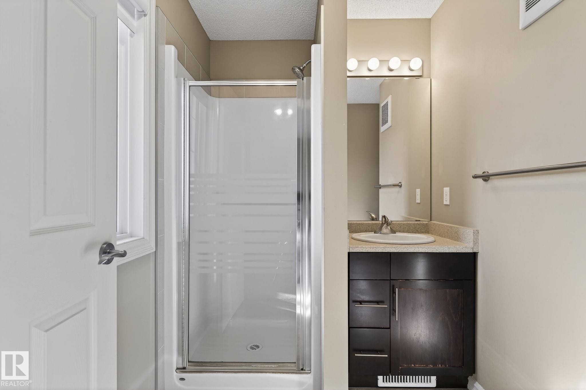 Full bathroom with a stall shower, vanity, and a textured ceiling - 2338 Casselman Crescent, Edmonton, AB - Indoor Photo Showing Bathroom