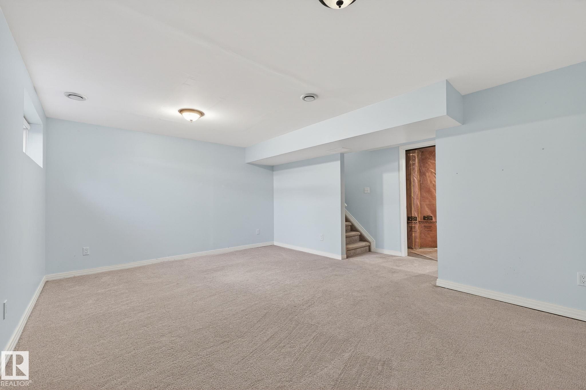 Spare room featuring stairs and carpet - 2338 Casselman Crescent, Edmonton, AB - Indoor