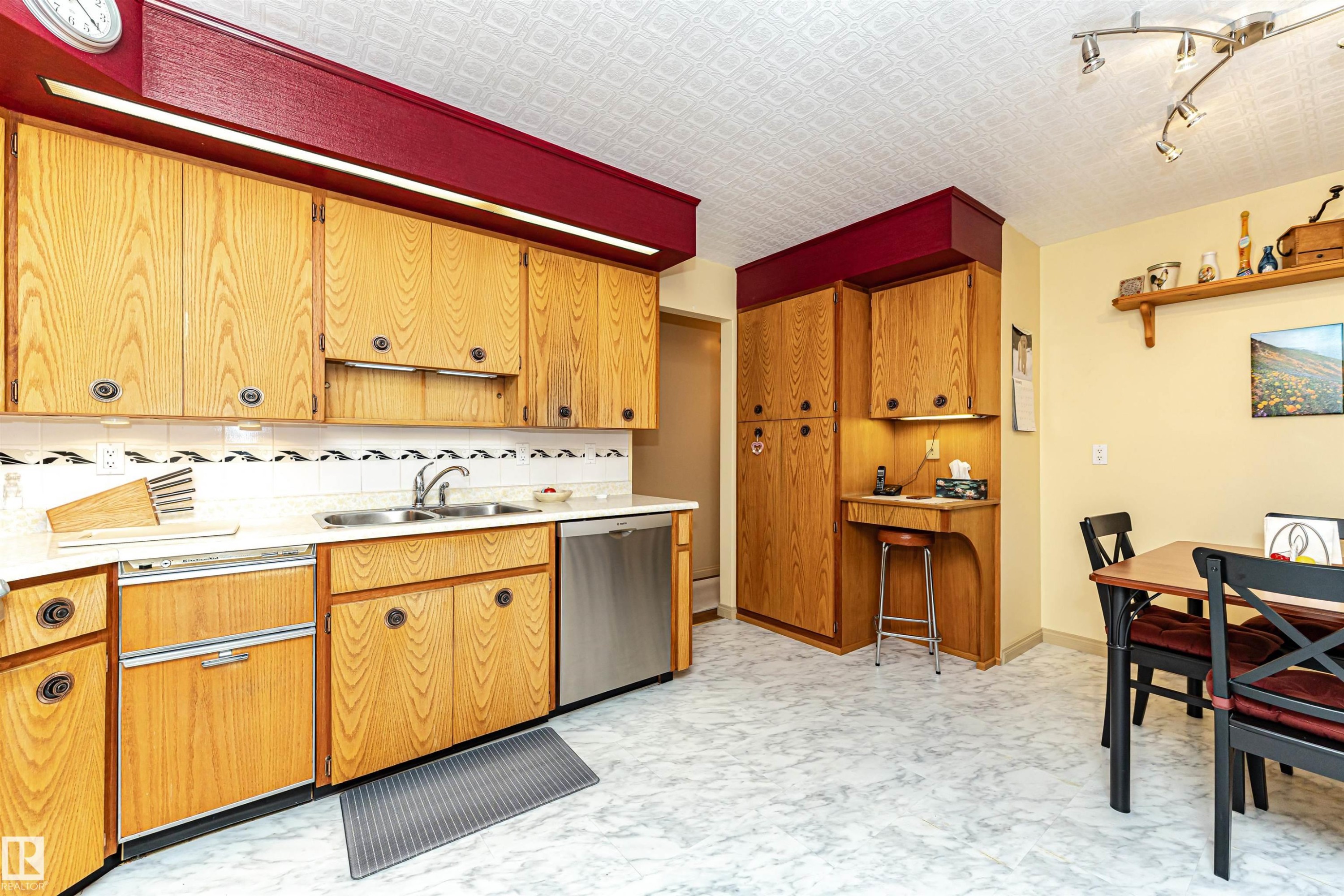 Kitchen with open shelves, light countertops, dishwasher, rail lighting, and wood finish cabinets - 2112 67 Street Nw, Edmonton, AB - Indoor Photo Showing Kitchen With Double Sink