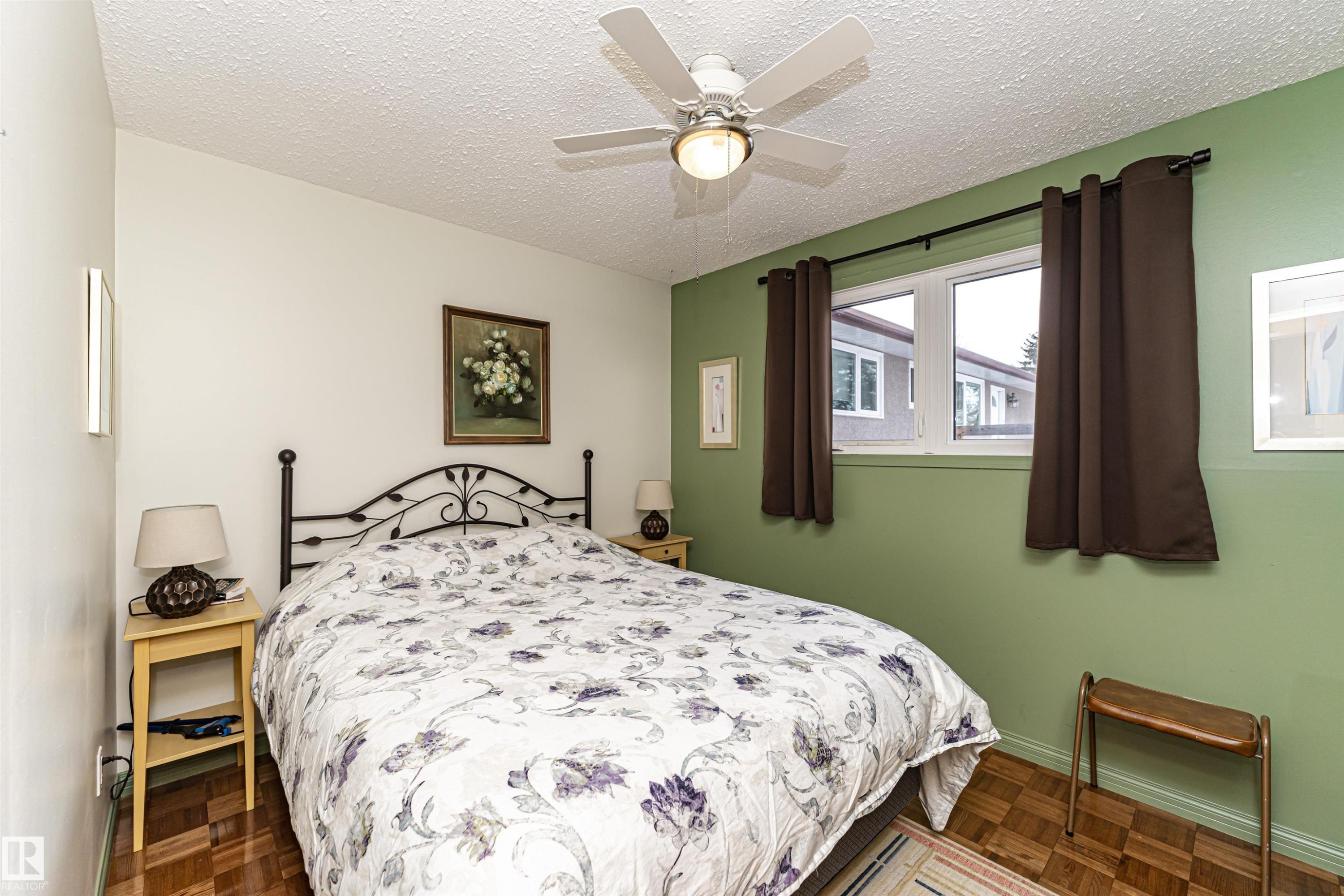 Bedroom featuring a textured ceiling, parquet flooring, and a ceiling fan - 2112 67 Street Nw, Edmonton, AB - Indoor Photo Showing Bedroom