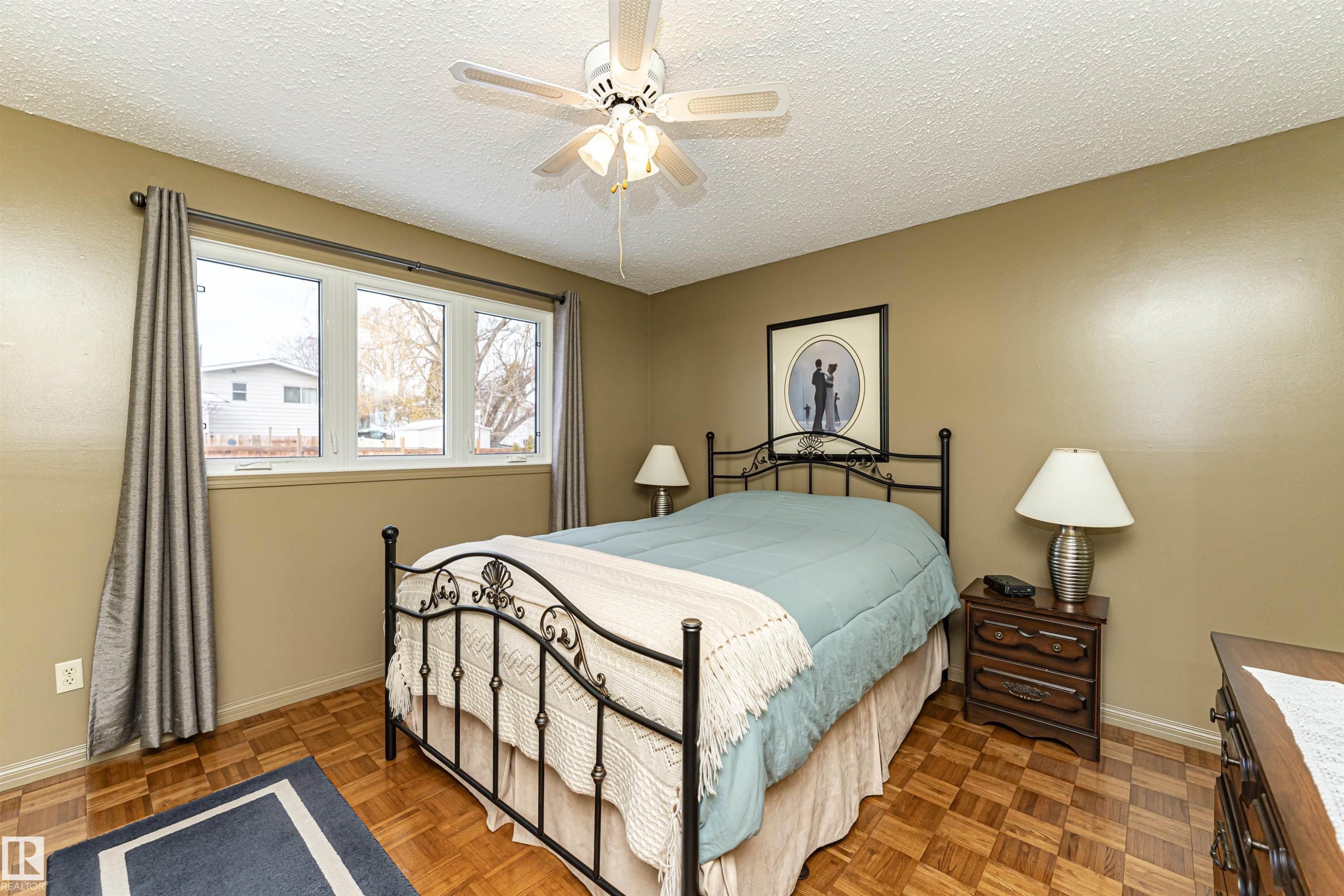 Bedroom with a textured ceiling, a ceiling fan, and parquet floors - 2112 67 Street Nw, Edmonton, AB - Indoor Photo Showing Bedroom