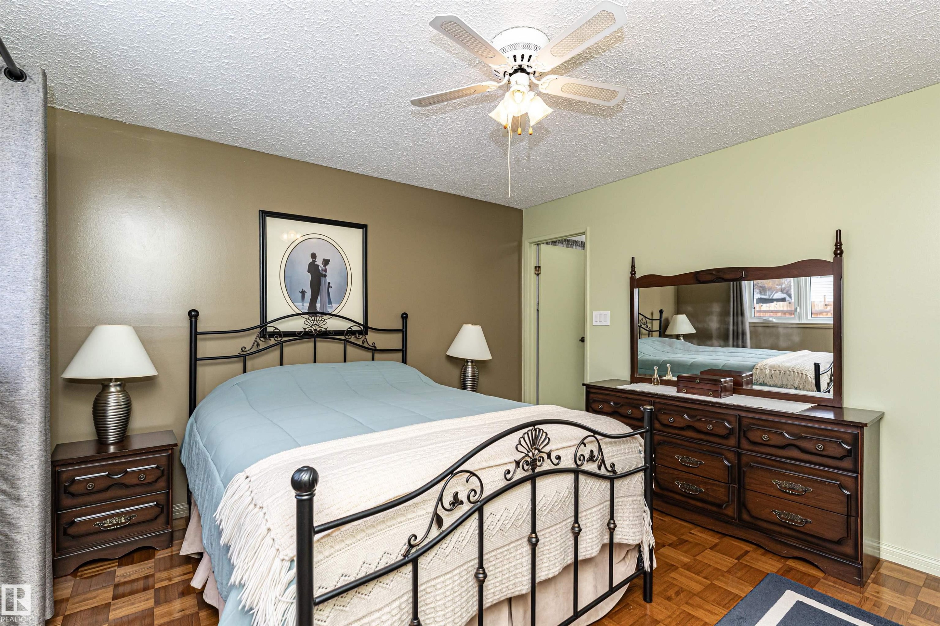 Bedroom featuring a textured ceiling, parquet floors, and ceiling fan - 2112 67 Street Nw, Edmonton, AB - Indoor Photo Showing Bedroom