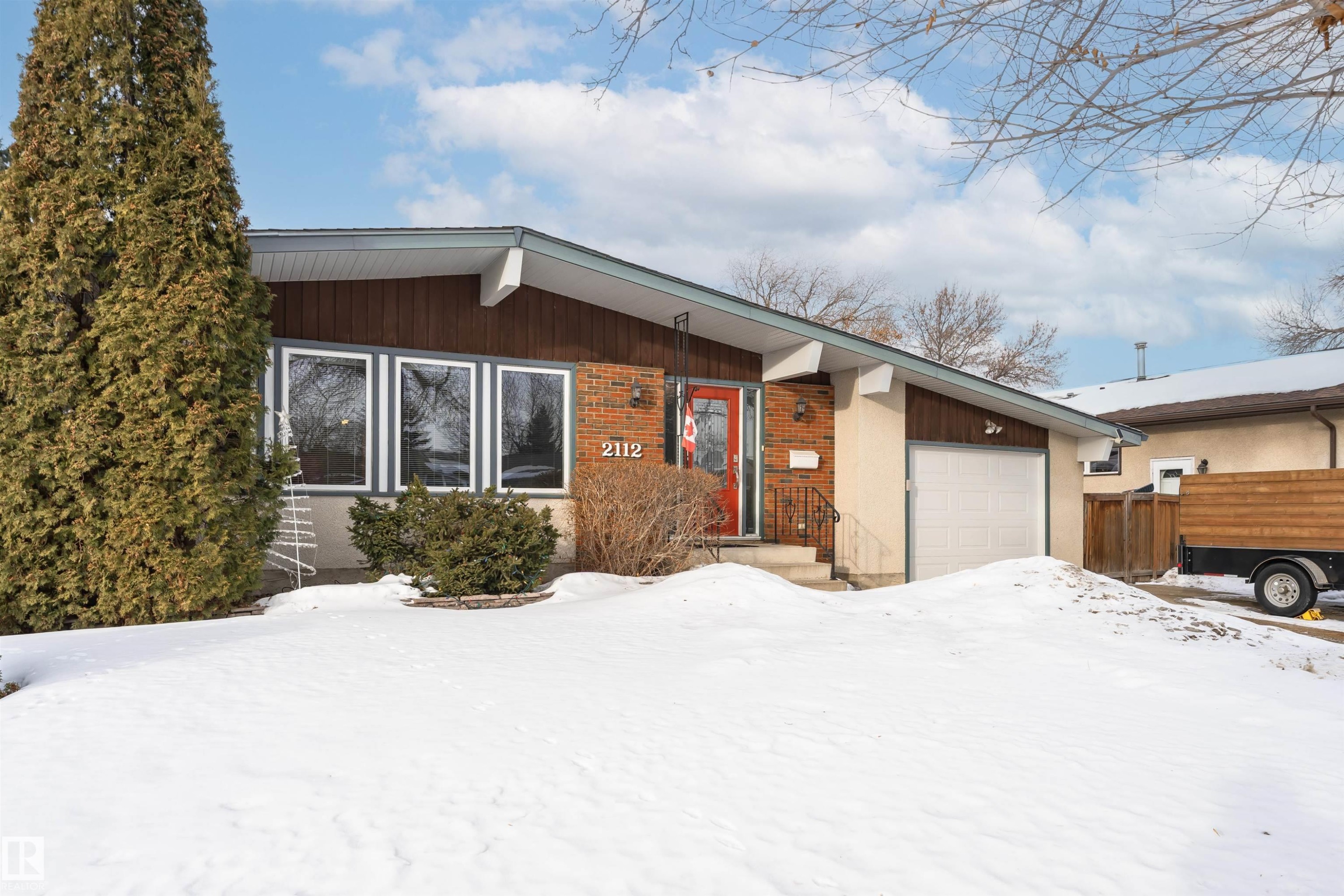 View of front of house with an attached garage and brick siding - 2112 67 Street Nw, Edmonton, AB - Outdoor