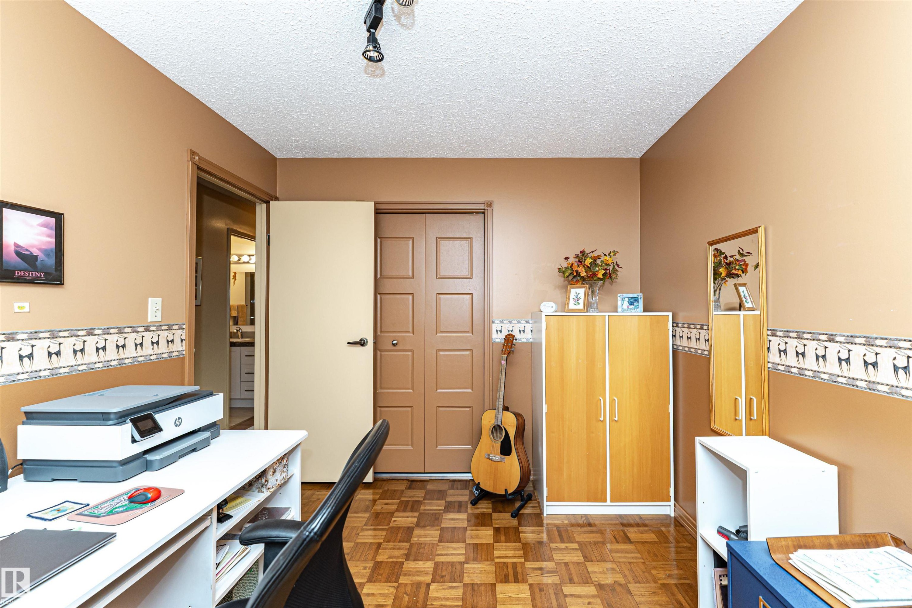 Home office with parquet flooring, a textured ceiling, and track lighting - 2112 67 Street Nw, Edmonton, AB - Indoor