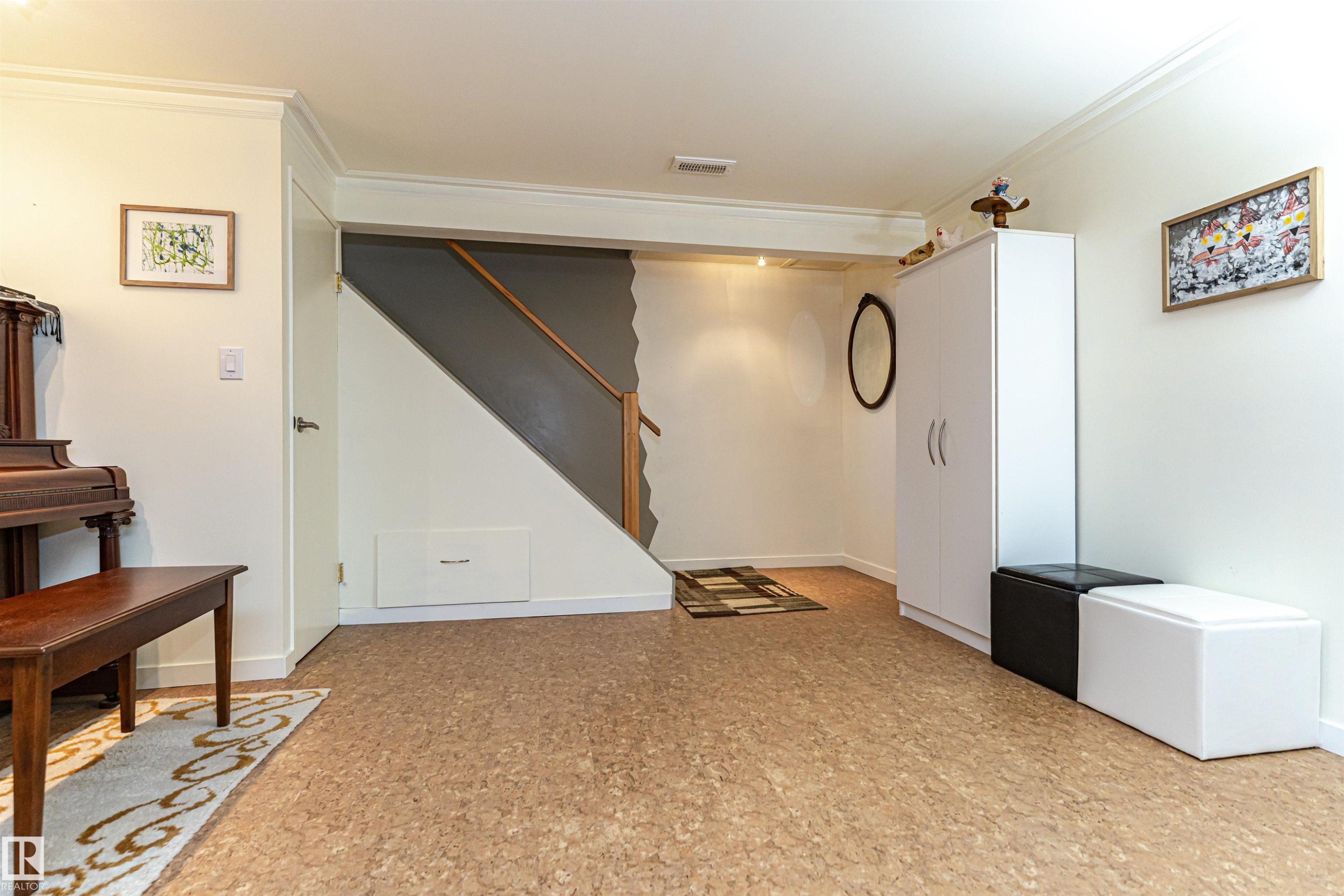 Basement featuring ornamental molding and light floors - 2112 67 Street Nw, Edmonton, AB - Indoor Photo Showing Other Room