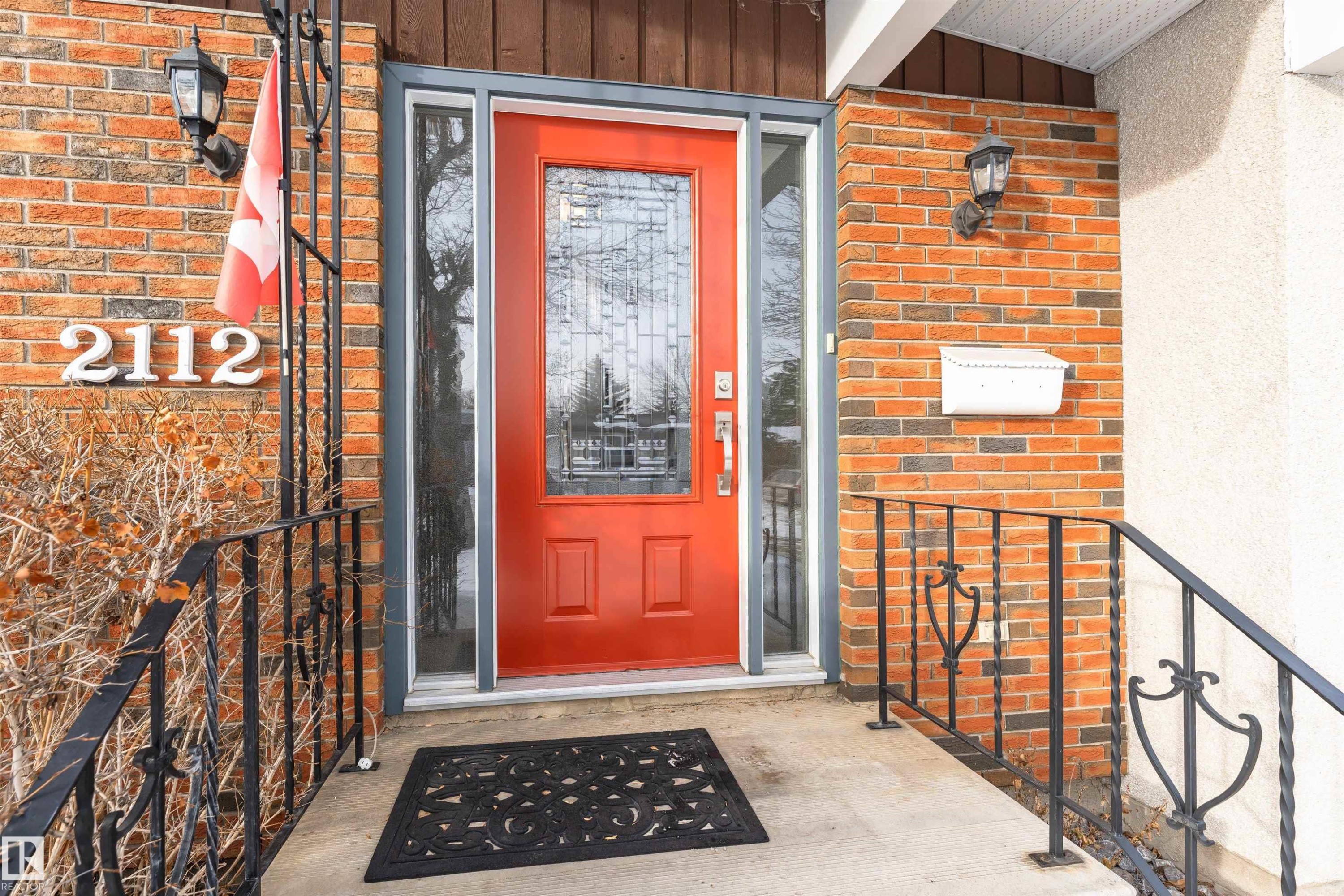 View of exterior entry with brick siding and board and batten siding - 2112 67 Street Nw, Edmonton, AB - Outdoor With Exterior