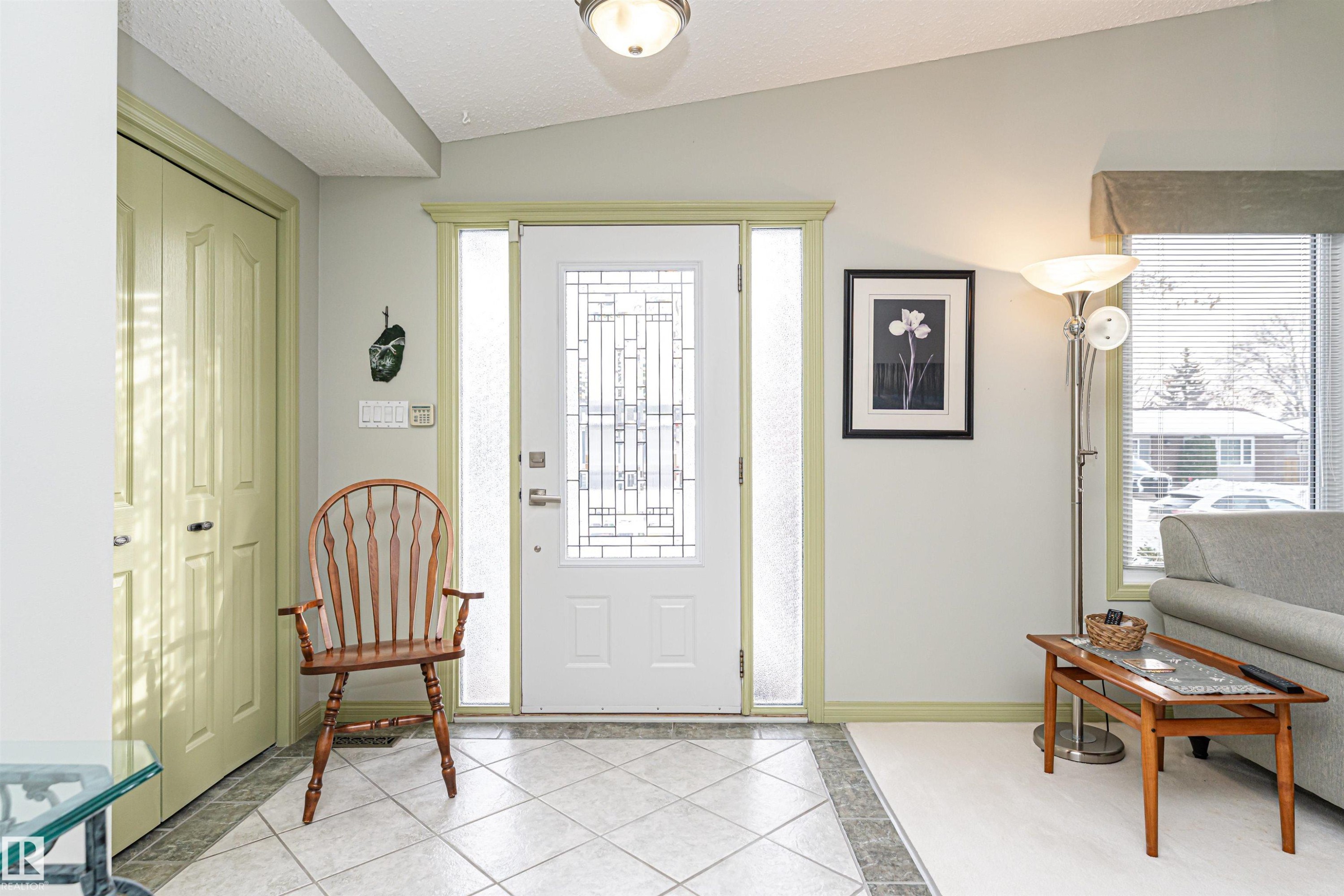 Foyer entrance featuring light tile patterned flooring and inlaid floor details - 2112 67 Street Nw, Edmonton, AB - Indoor Photo Showing Other Room