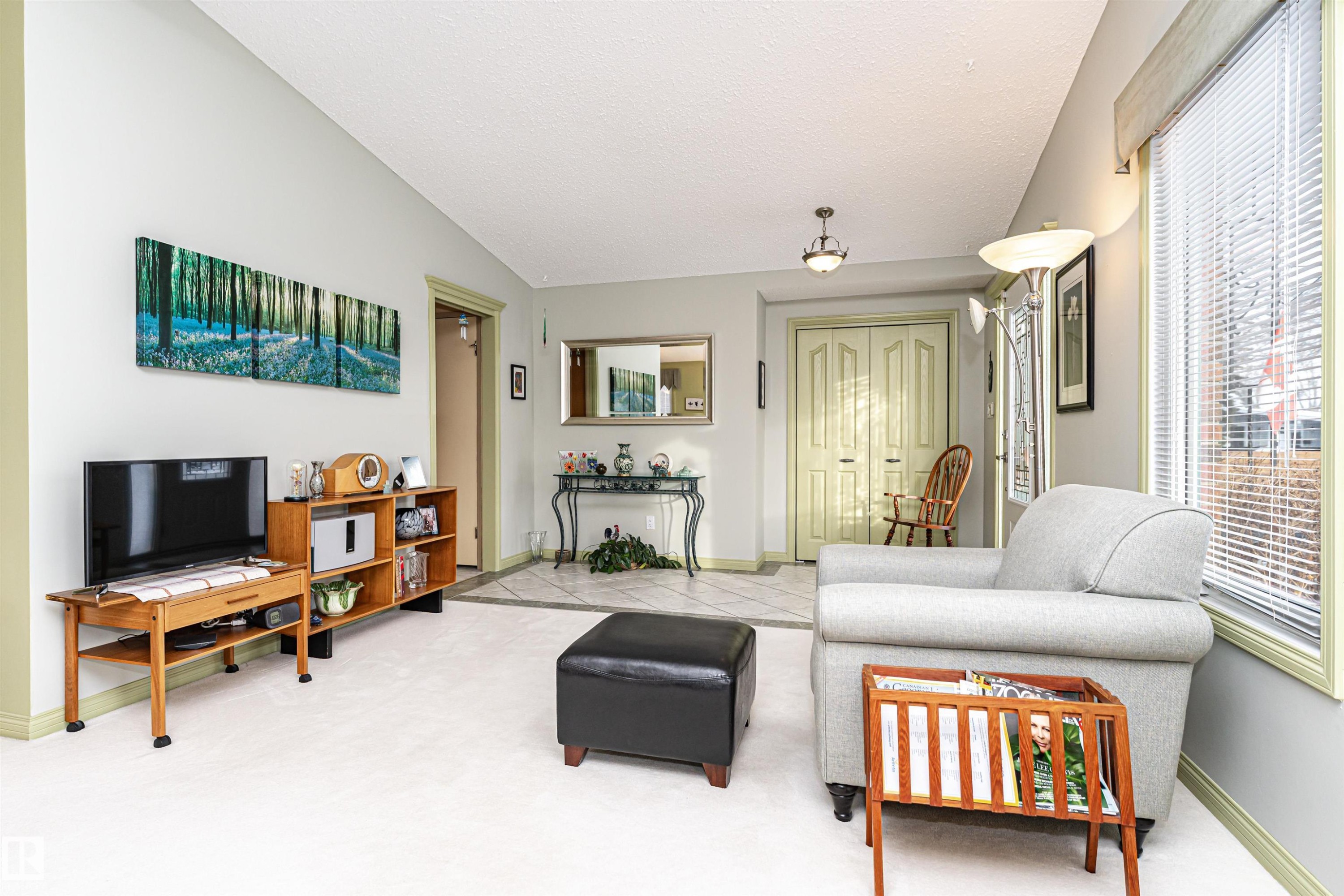 Living area with baseboards and carpet - 2112 67 Street Nw, Edmonton, AB - Indoor Photo Showing Living Room