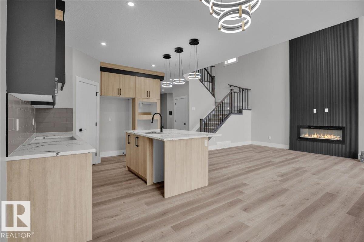 8419 Mayday Link, Edmonton, AB - Indoor Photo Showing Kitchen With Fireplace