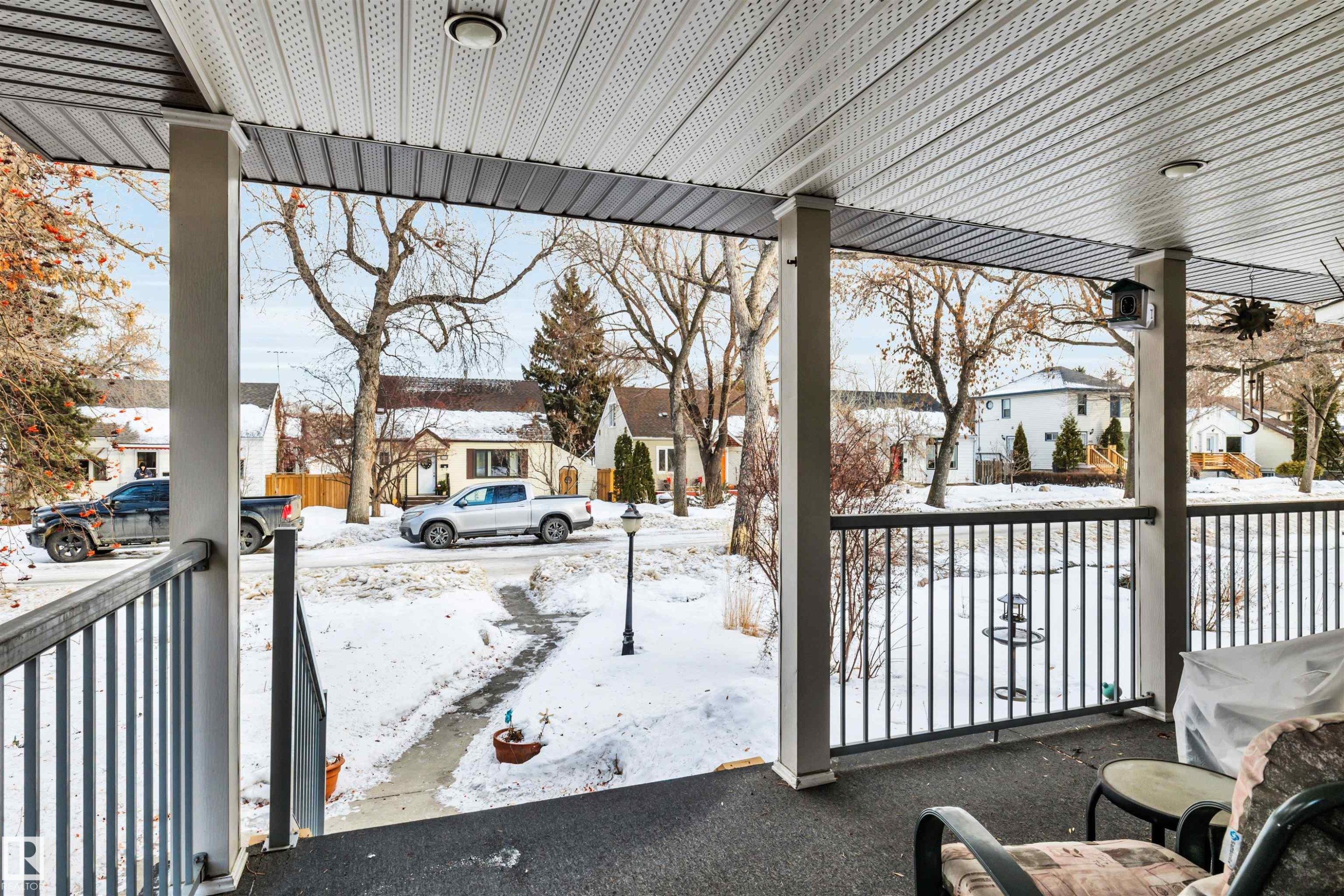 Snow covered patio with a residential view and covered porch - 11432 71 Street, Edmonton, AB - Outdoor