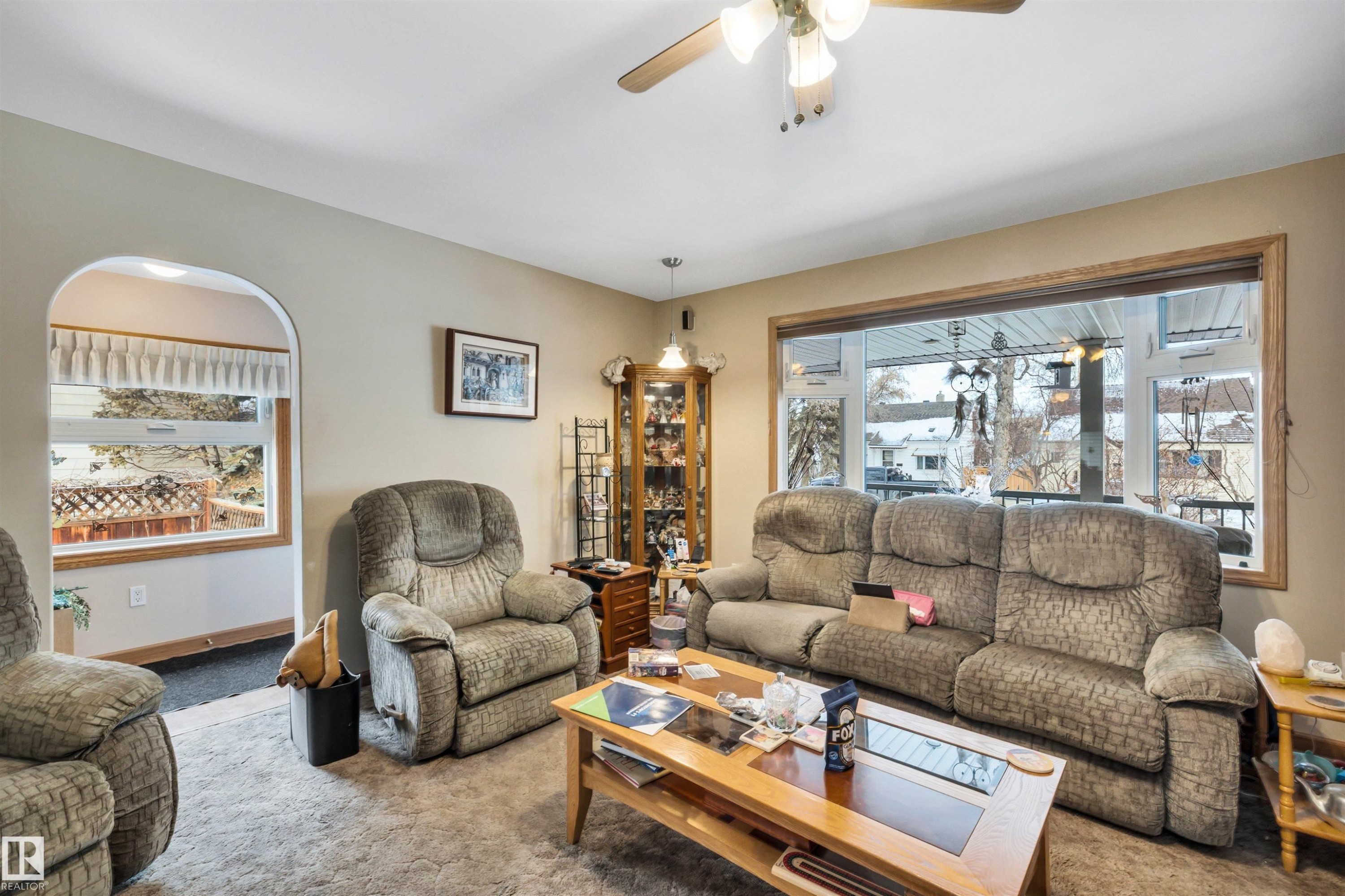 Living area featuring carpet flooring and a ceiling fan - 11432 71 Street, Edmonton, AB - Indoor Photo Showing Living Room