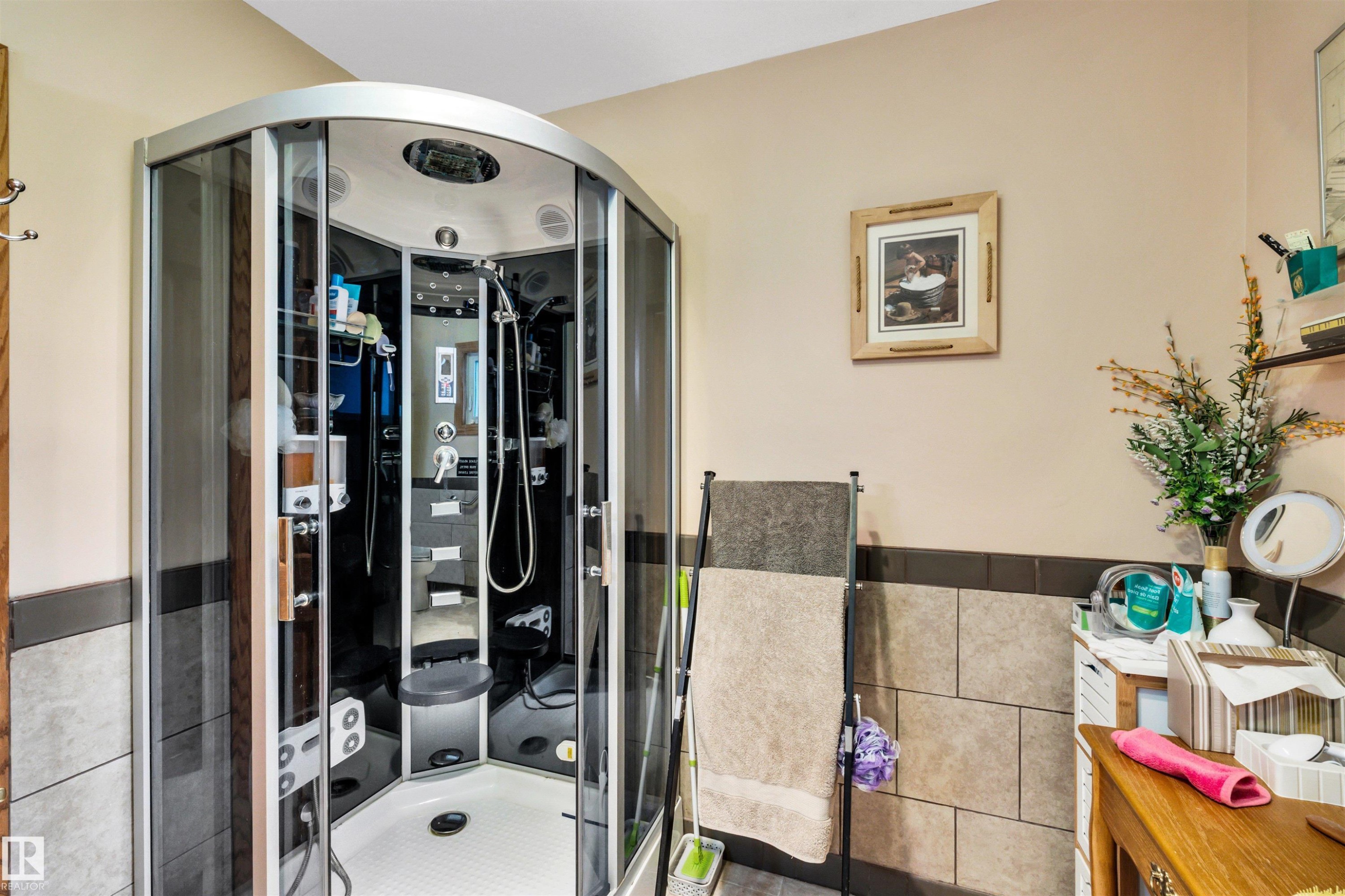 Full bath featuring tile walls, a stall shower, and a wainscoted wall - 11432 71 Street, Edmonton, AB - Indoor Photo Showing Bathroom