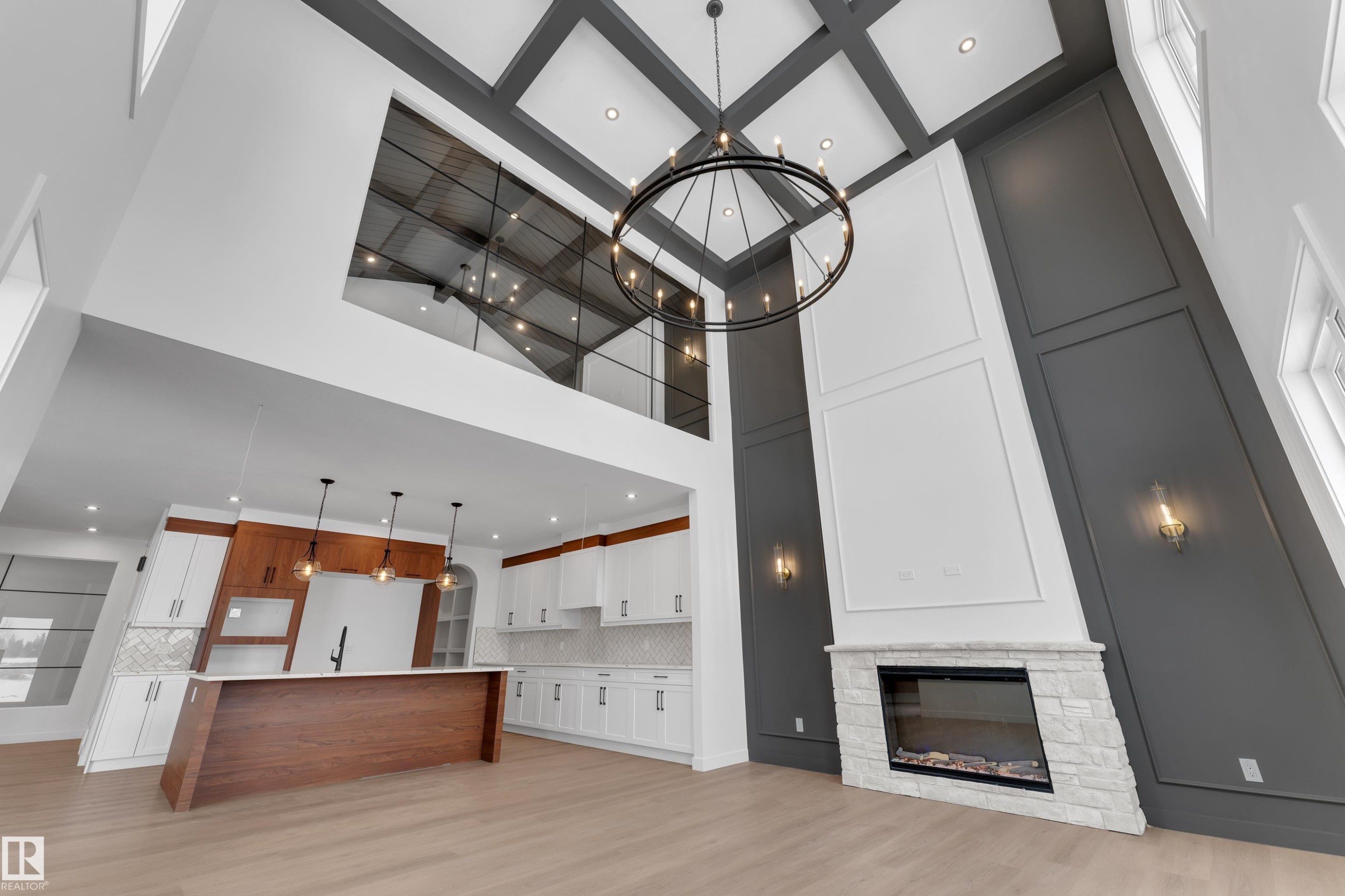 Unfurnished living room featuring recessed lighting, a fireplace, light wood-style flooring, and high coffered ceiling - 40 Grayson Green, Stony Plain, AB - Indoor With Fireplace