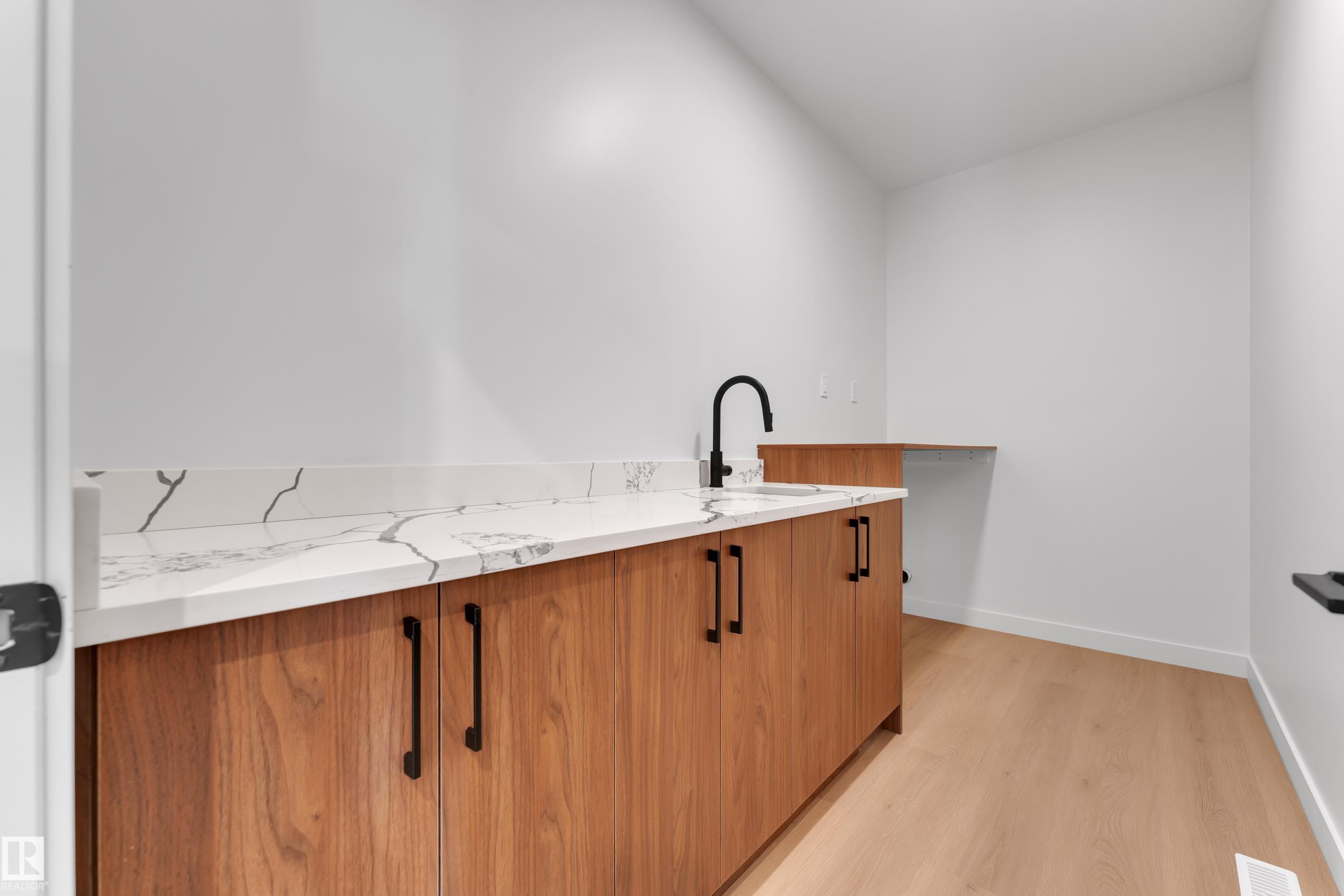 Laundry area with light wood finished floors and baseboards - 40 Grayson Green, Stony Plain, AB - Indoor