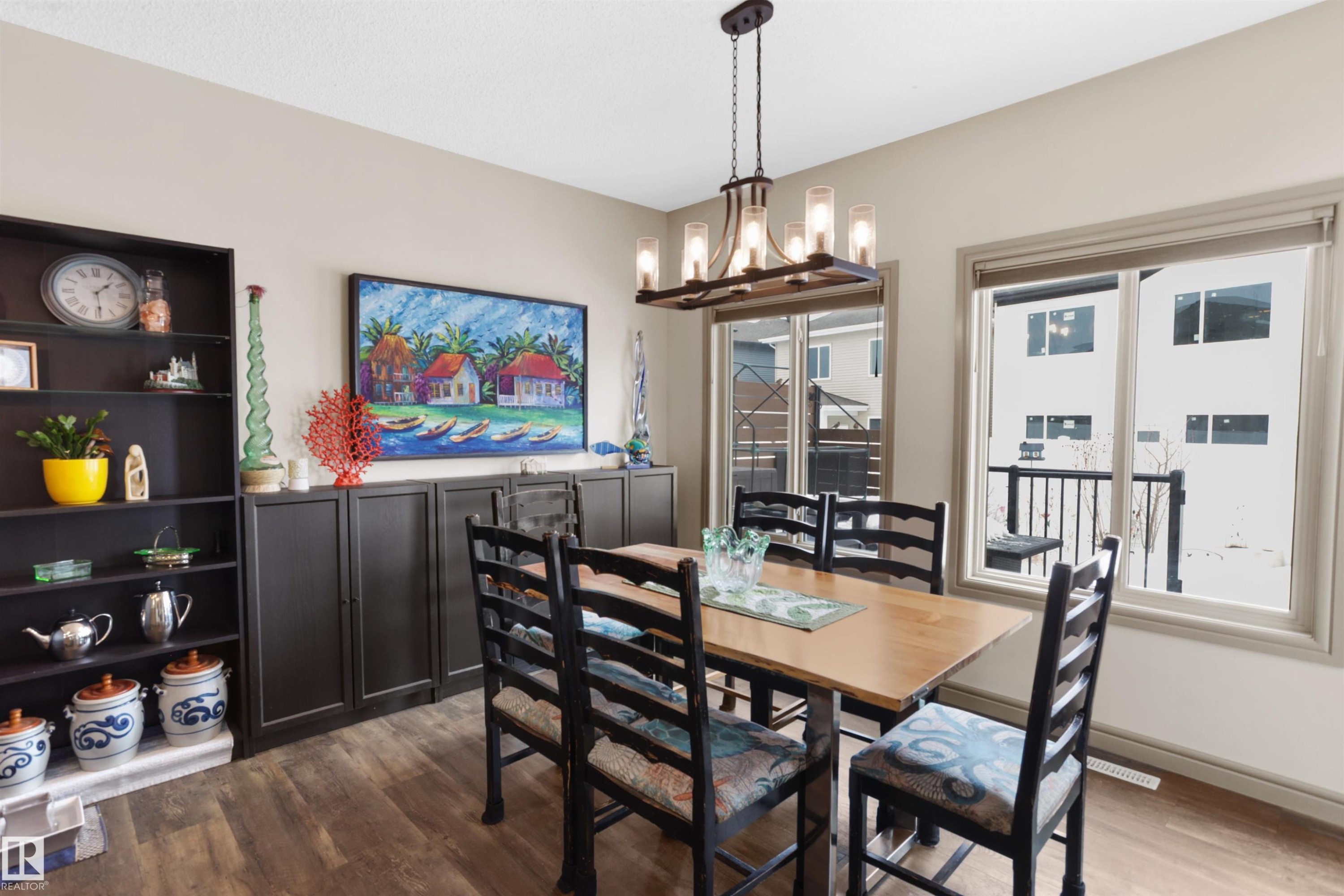 Dining area with dark wood-type flooring and hanging lights - 97 Astoria Point(E), Devon, AB - Indoor Photo Showing Dining Room