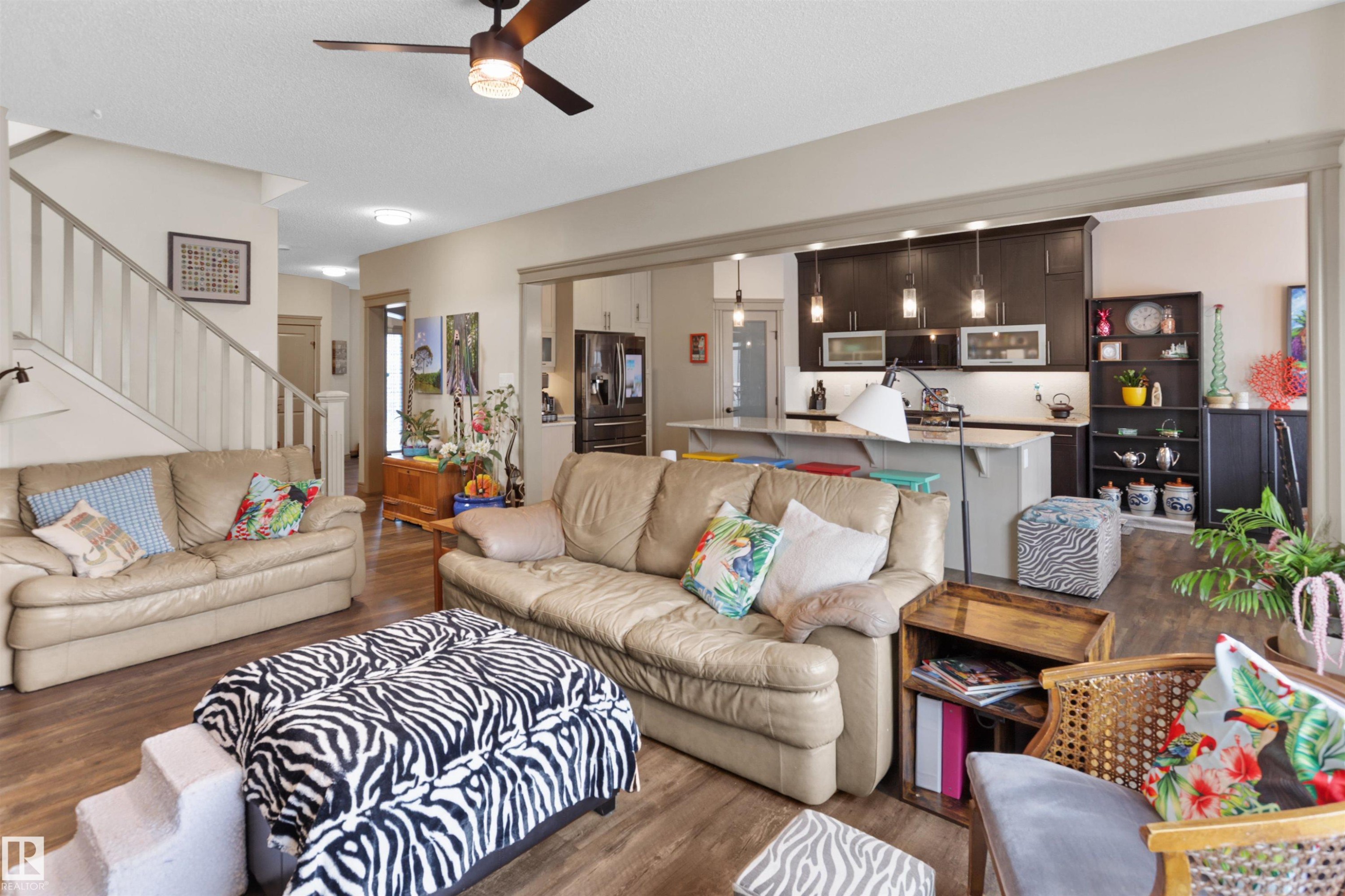 Living room with a ceiling fan and wood finished floors - 97 Astoria Point(E), Devon, AB - Indoor Photo Showing Living Room