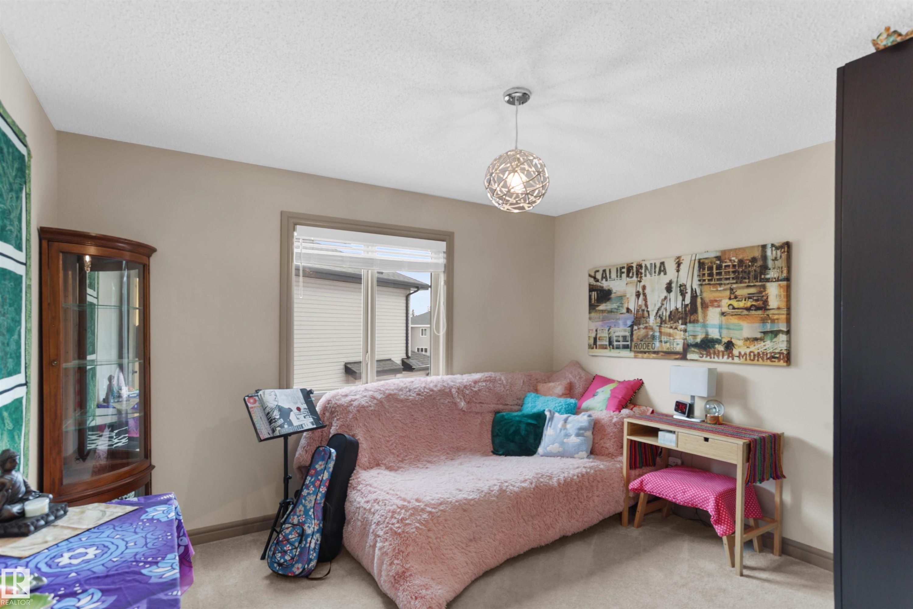 Carpeted bedroom featuring baseboards and a textured ceiling - 97 Astoria Point(E), Devon, AB - Indoor Photo Showing Bedroom