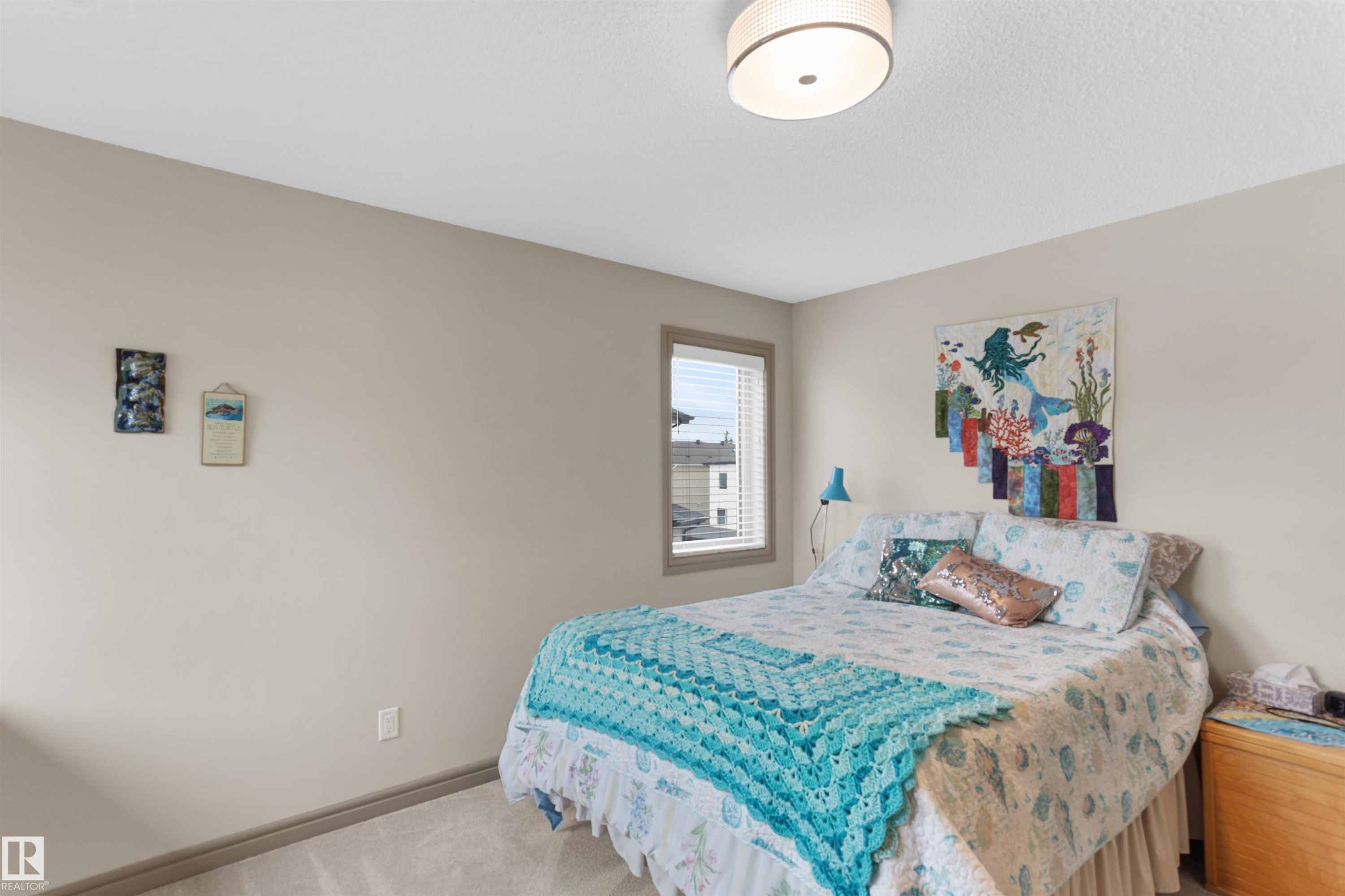 Bedroom with carpet floors and baseboards - 97 Astoria Point(E), Devon, AB - Indoor Photo Showing Bedroom