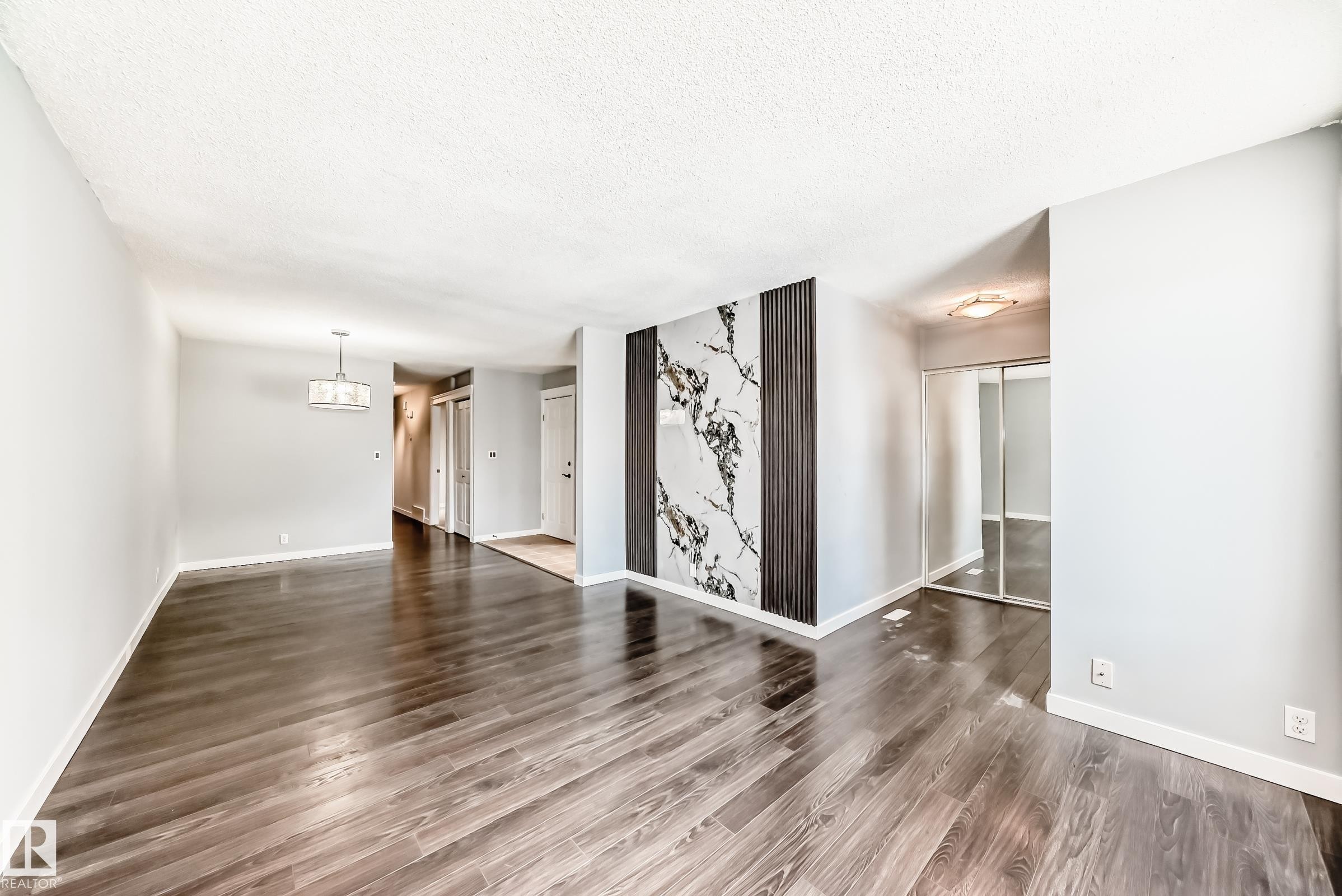 Unfurnished living room with a textured ceiling and dark wood-type flooring - 10331 153 Street, Edmonton, AB - Indoor Photo Showing Other Room