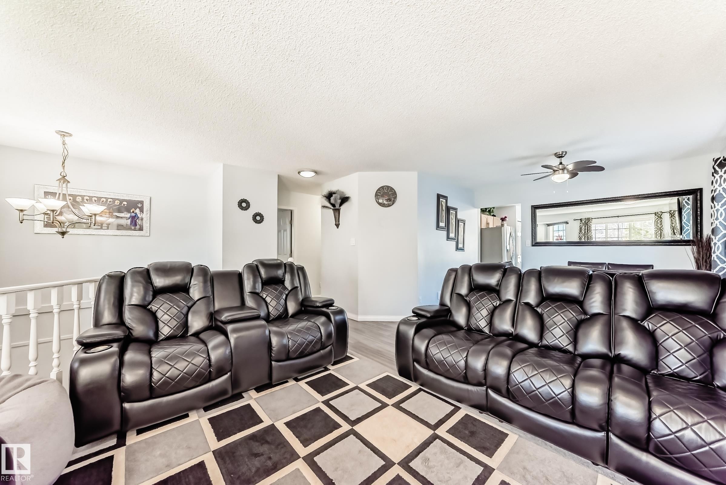 Living room featuring a textured ceiling, a chandelier, and a ceiling fan - 6 Jefferson Road, Edmonton, AB - Indoor Photo Showing Living Room